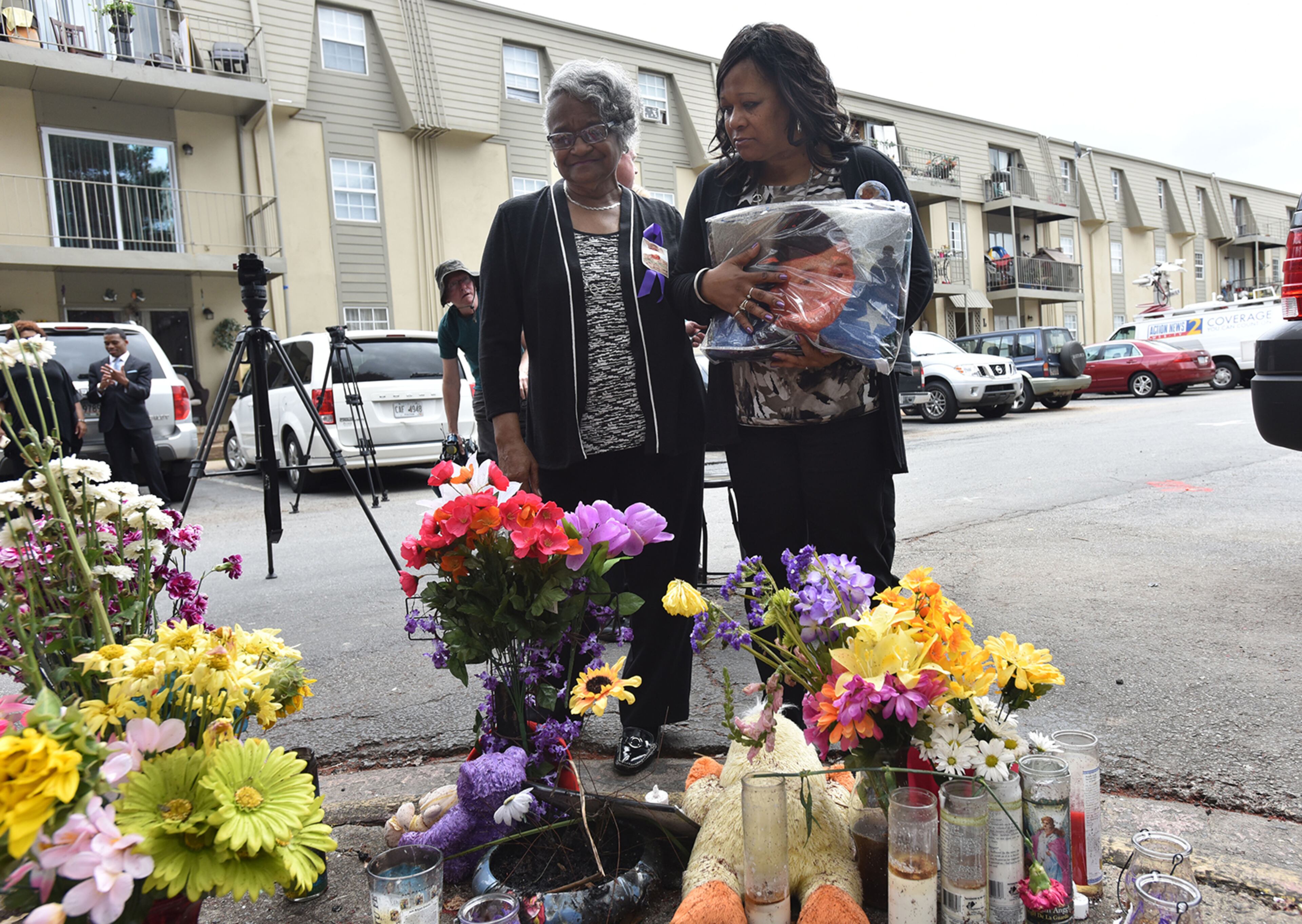 Mother of Anthony Hill, Carolyn Baylor-Giummo, right, and grandmother of Anthony Hill, Theola Baylor, look a memorial at the apartment complex where Anthony Hill, 26, was shot and killed by a DeKalb County police officer. (HYOSUB SHIN / HSHIN@AJC.COM)