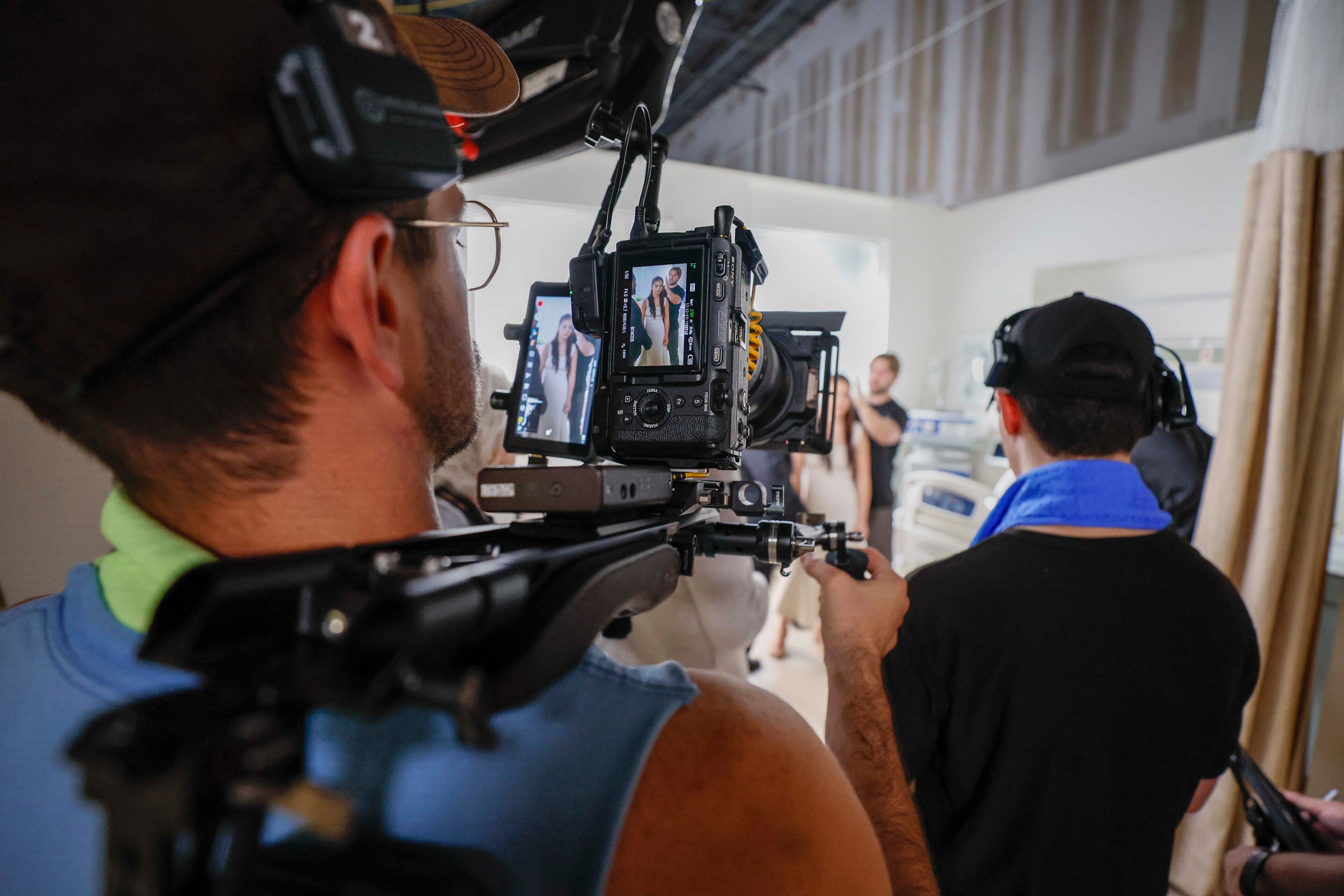A camera crew member shoots a scene filmed in a vertical format as actors perform in a production by Crazy Stone Studio for a project called for now "Billionaire Defense Contractor" on Wednesday, June 25, 2025.
(Miguel Martinez/ AJC)