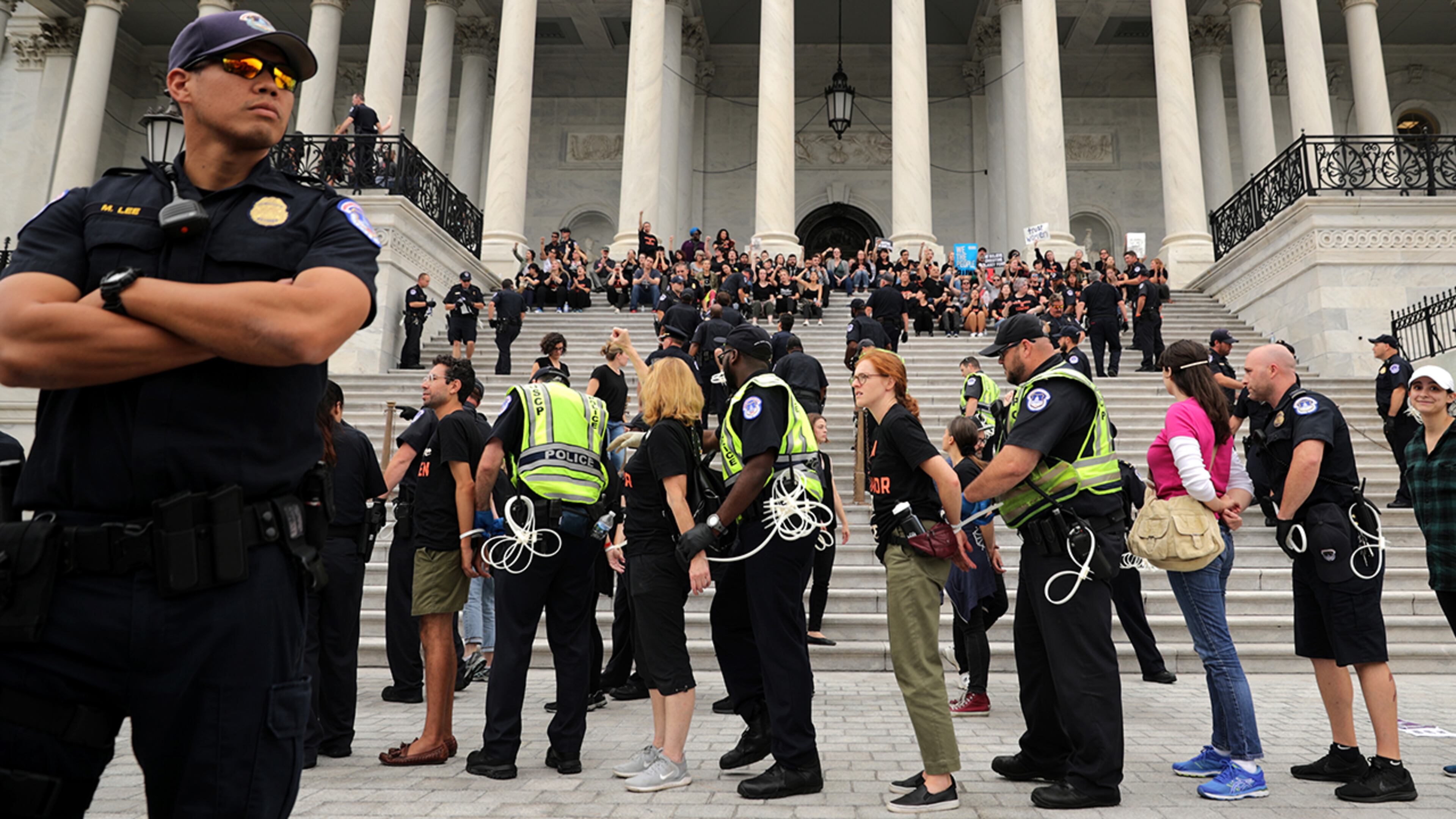 WASHINGTON, DC - OCTOBER 06: U.S. Capitol Police arrest hundreds of protesters after they occupied the center steps of the East Front of the U.S. Capitol to demonstrate against the confirmation of Supreme Court nominee Judge Brett Kavanaugh October 06, 2018 in Washington, DC. The Senate is scheduled to vote on Kavanaugh's confirmation later in the day. (Photo by Chip Somodevilla/Getty Images)