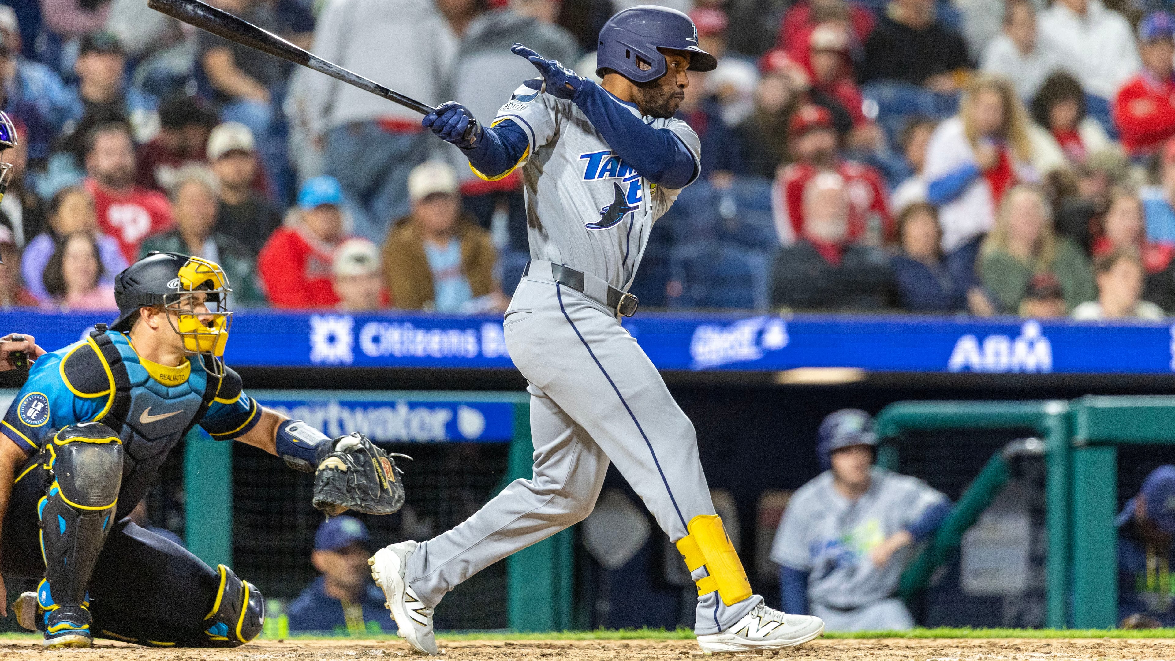 Tampa Bay Rays' Cedric Mullins, right, follows through on a single during the ninth inning of a baseball game against the Philadelphia Phillies, Friday, Sept. 25, 2026, in Philadelphia. (AP Photo/Laurence Kesterson)