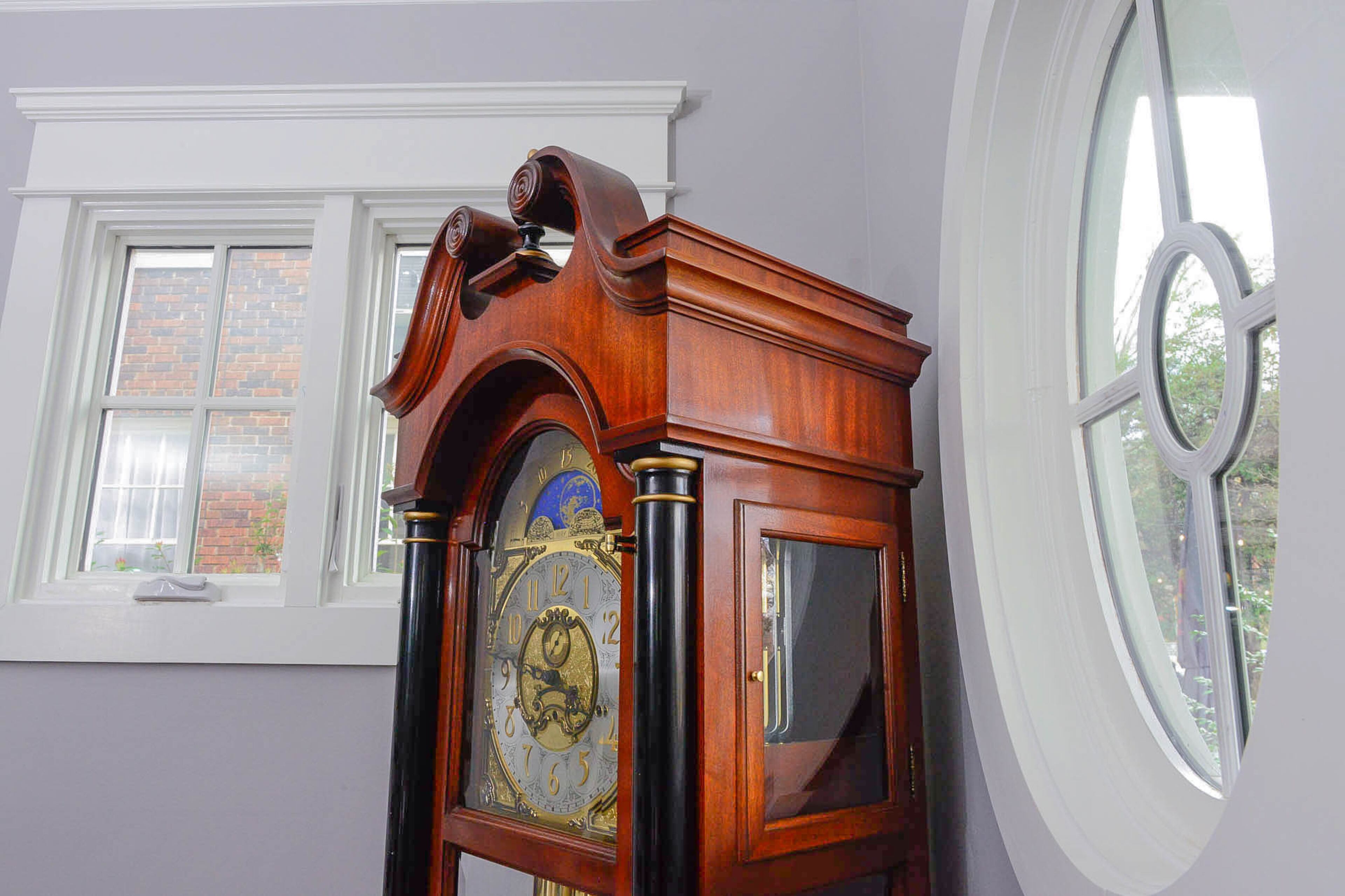 A grandfather clock is a distinguishing interior feature, among the traditional furnishings, and the oval window is positioned near the front door of the home, modeled after the original 1916 house.