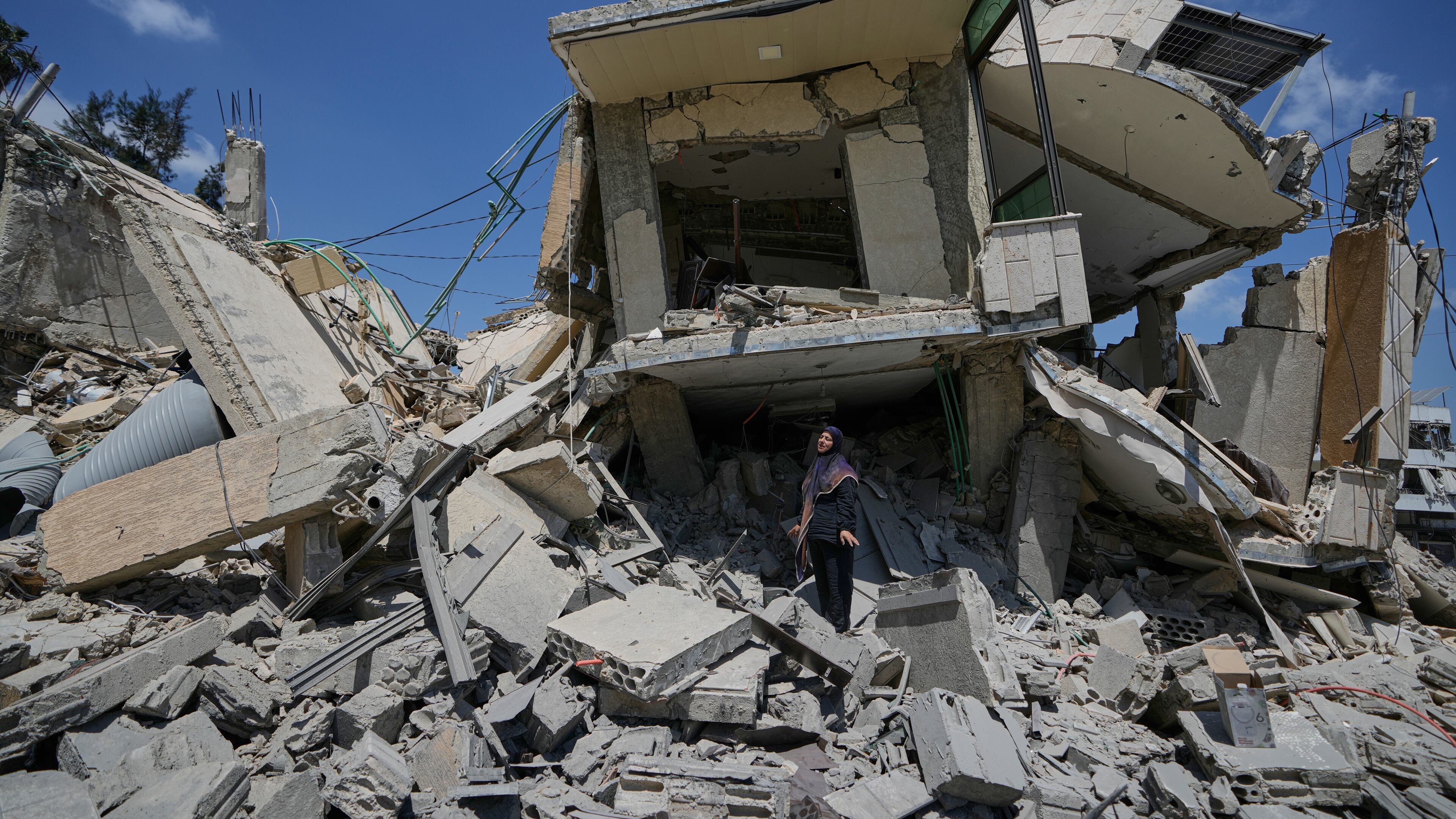 Hanan Qubaisi inspects her house destroyed in previous Israeli airstrikes in the town of Nabatiyeh, southern Lebanon, Wednesday, June 24, 2026, after a ceasefire between Israel and Hezbollah. (AP Photo/Bilal Hussein)