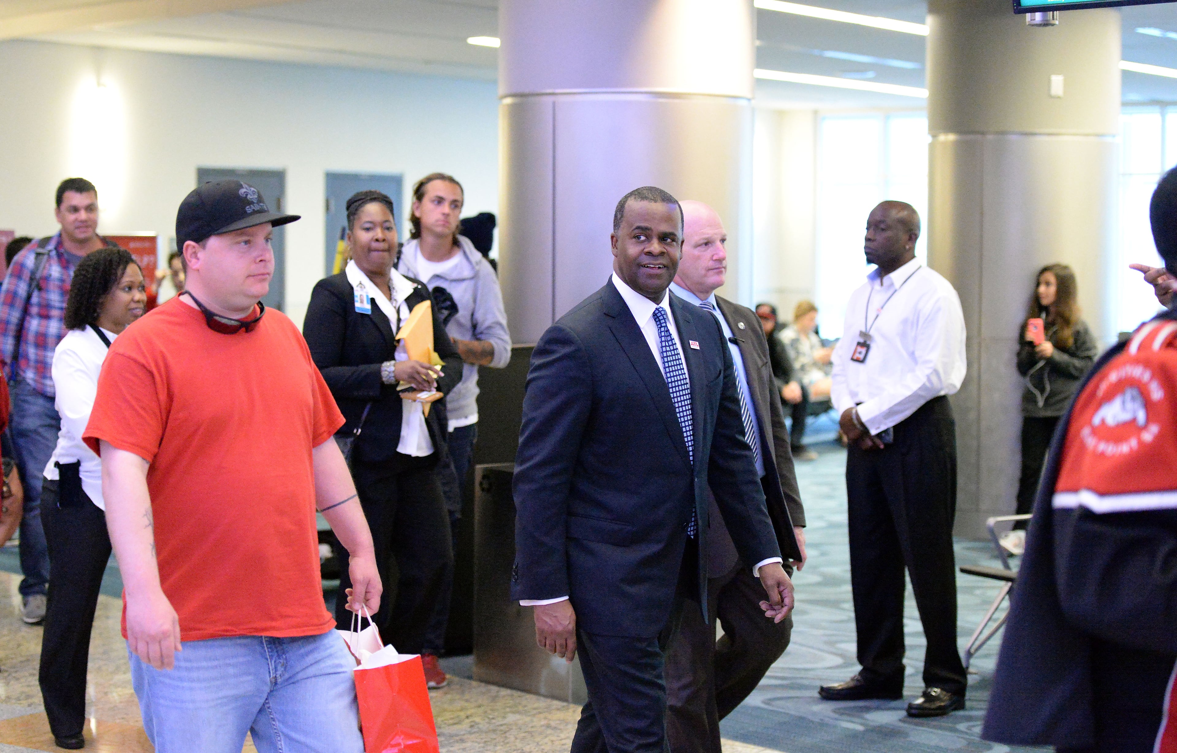 Atlanta Mayor Kasim Reed walks with 100 millionth passenger Larry Kendrick through the International terminal following the ceremony. Hartsfield-Jackson International Airport awarded its 100 millionth passenger for 2015 with prizes including a new car, two free airline tickets and a small crowd of officials and television cameras early Sunday December 27, 2015. The Atlanta airport, "the world's busiest" is the first airport in the world to handle 100 million passengers in a year. "It's our commitment that we maintain our position as the world's most traveled airport," said Atlanta Mayor Kasim Reed during remarks at the airport before the flight arrived Sunday morning. The winner, a man from Biloxi named Larry Kendrick who arrived at the airport in blue jeans, an orange t-shirt and a baseball cap, was surprised to learn upon landing that he had been selected as the 100 millionth passenger. KENT D. JOHNSON/ kdjohnson@ajc.com