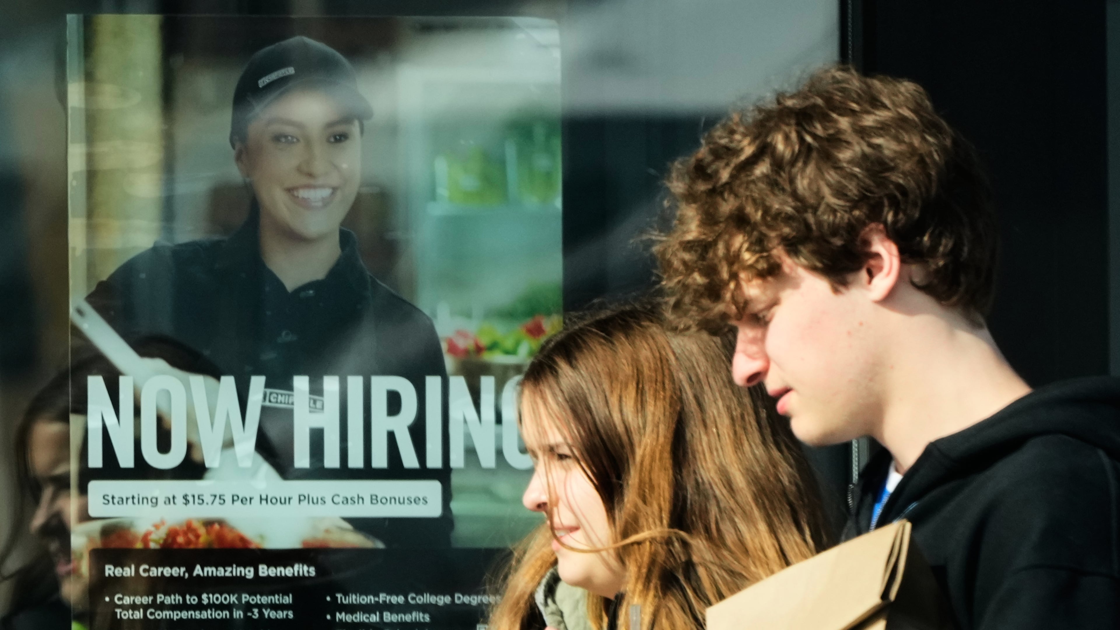A hiring sign is displayed at a restaurant, in Niles, Ill., Tuesday, April 7, 2026. (AP Photo/Nam Y. Huh)