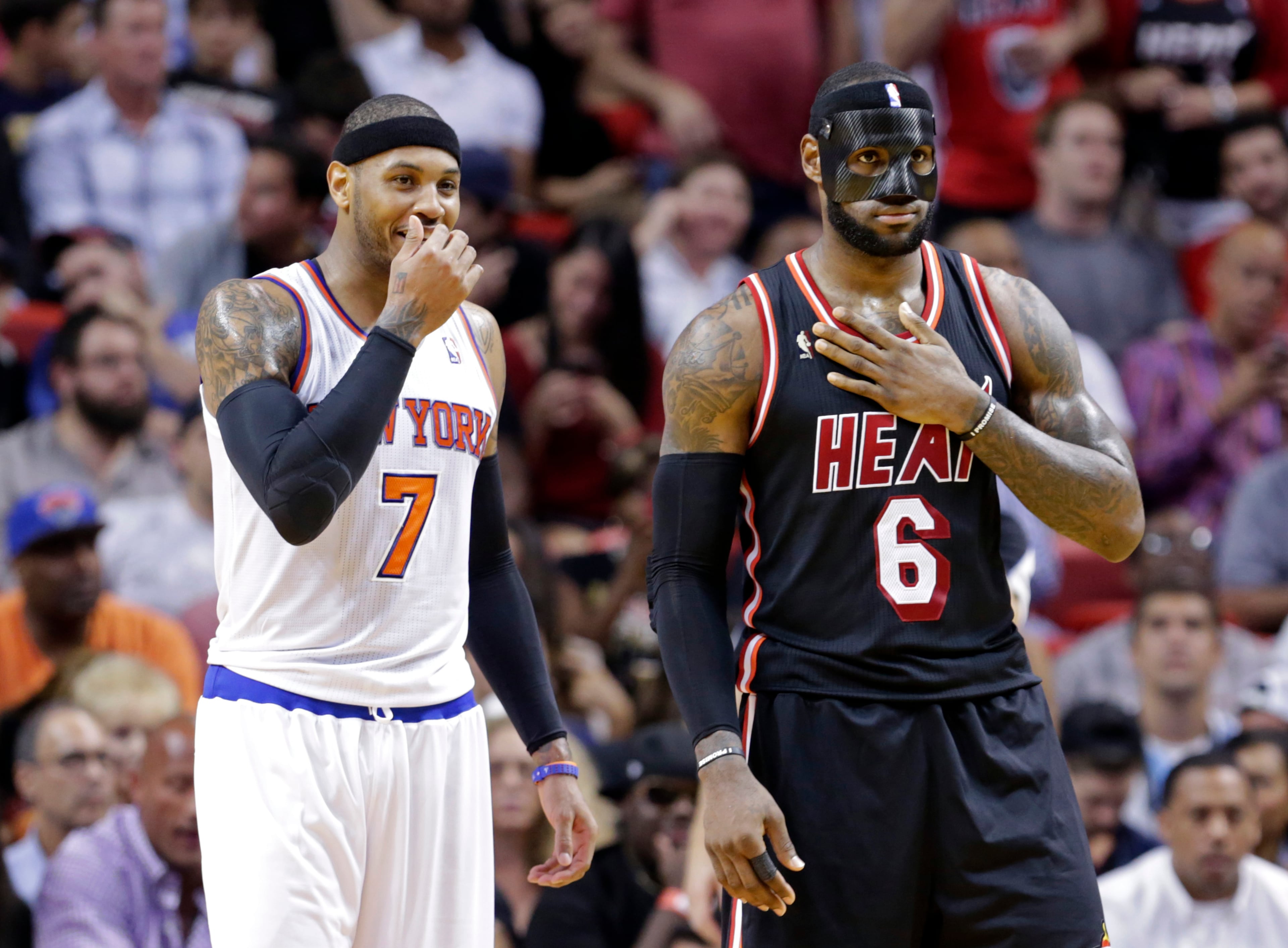 New York Knicks small forward Carmelo Anthony (7) and Miami Heat small forward LeBron James (6) talk during the second half Thursday. The Heat won 108-82.