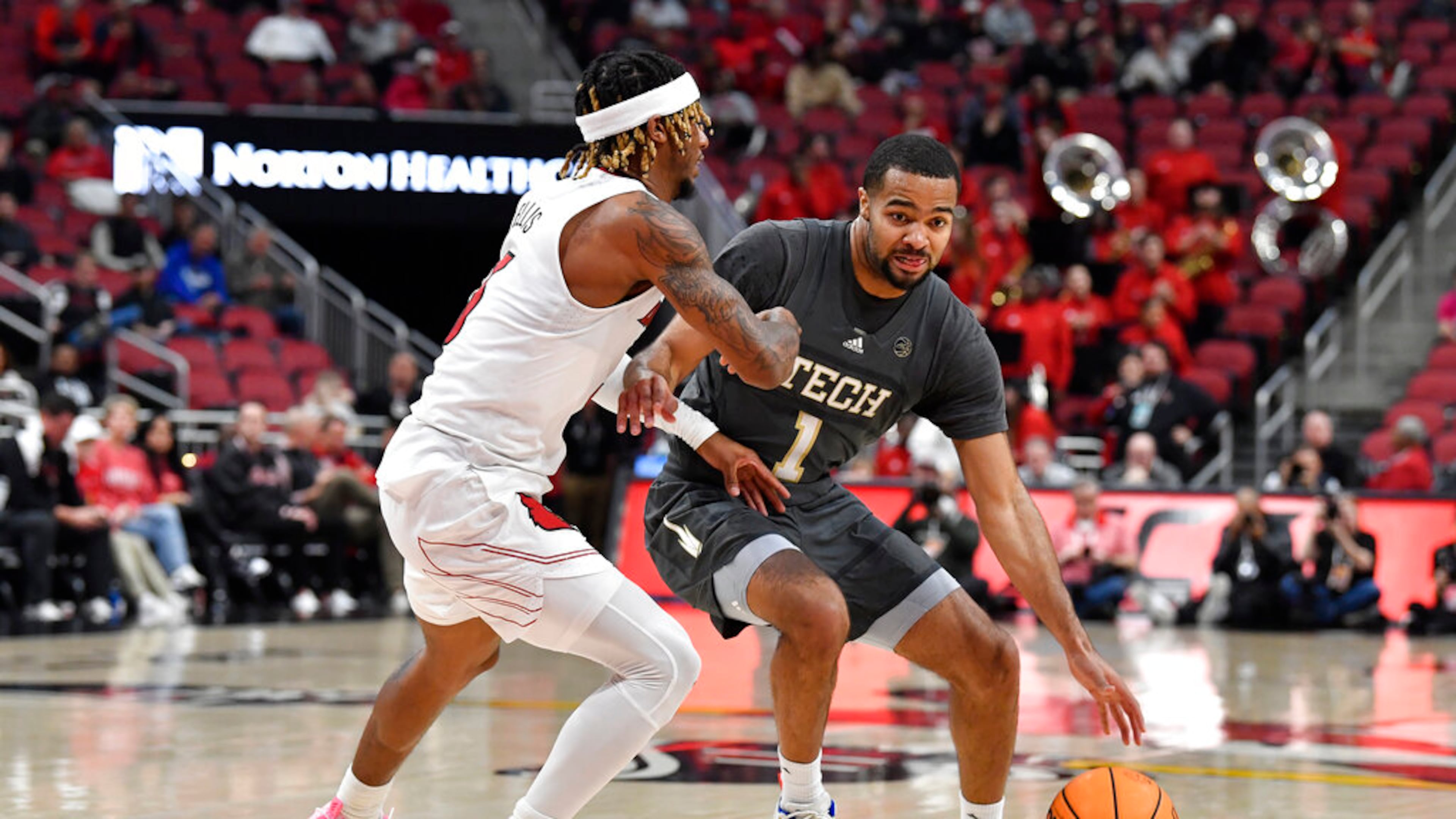 Georgia Tech guard Kyle Sturdivant (1) tries to get past Louisville guard El Ellis (3) during the first half in Louisville, Ky., Wednesday, Feb. 1, 2023. (AP Photo/Timothy D. Easley)