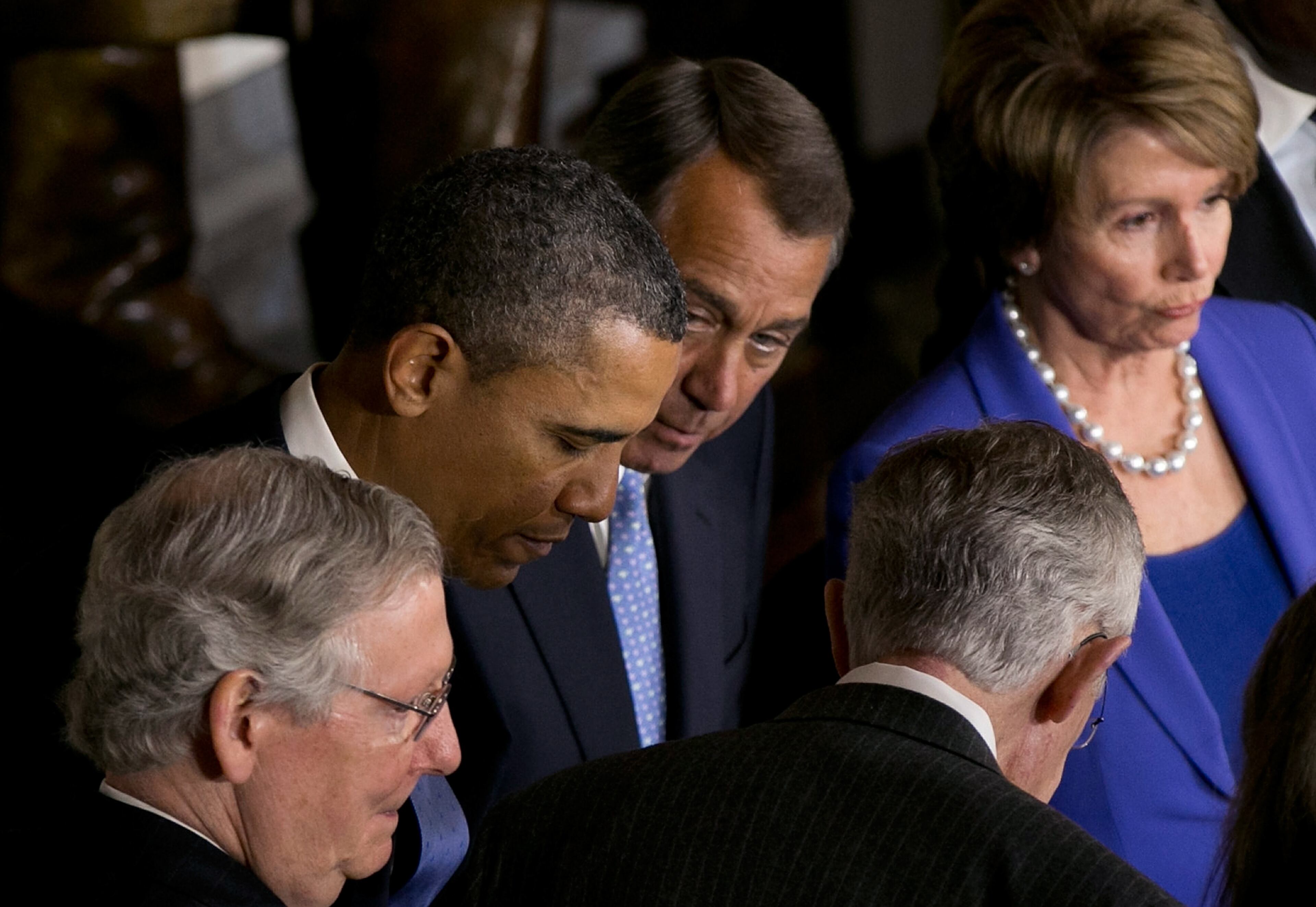 U.S. President Barack Obama and Speaker of the House John Boehner (R-OH) take part in a ceremony to unveil a statue honoring the late civil rights activist Rosa Parks in Statuary Hall of the U.S. Capitol February 27, 2013 in Washington, DC.