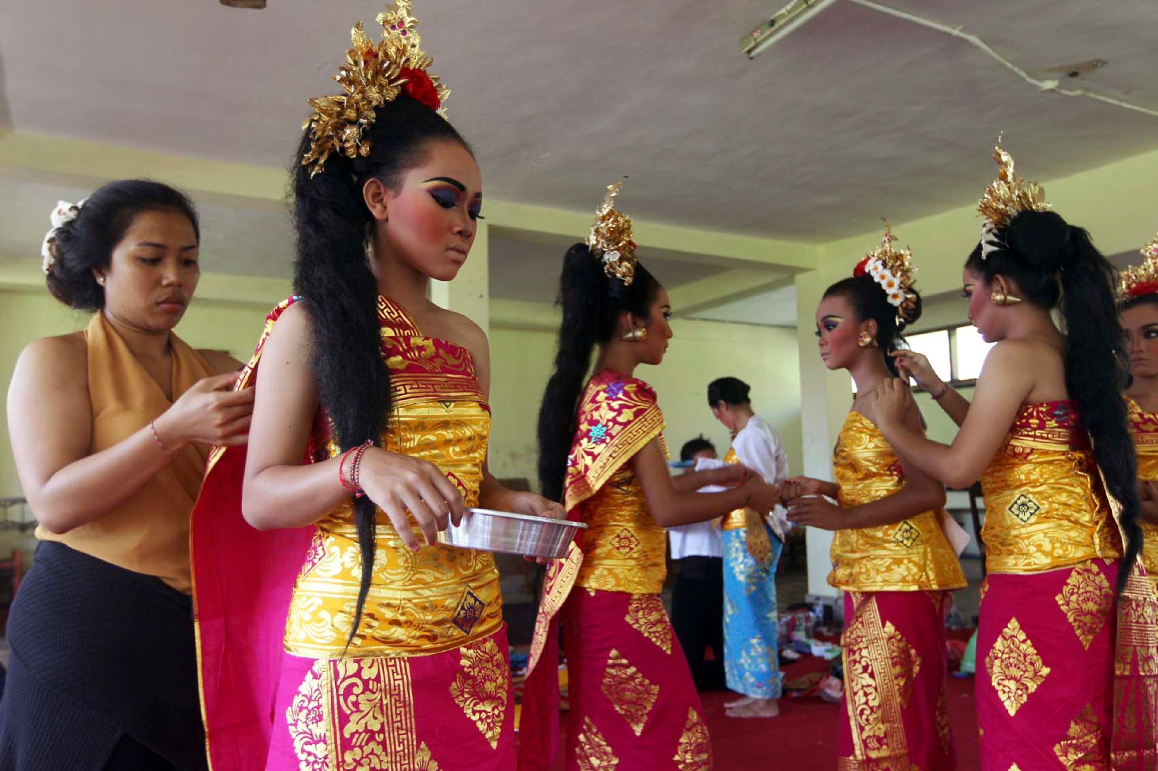 Balinese girls prepare for a performance during the Bali Arts Festival in Bali, Indonesia, Thursday, June 29, 2017. The resort island is currently holding a month-long annual Bali Arts Festival until July 8. (AP Photo/Firdia Lisnawati)