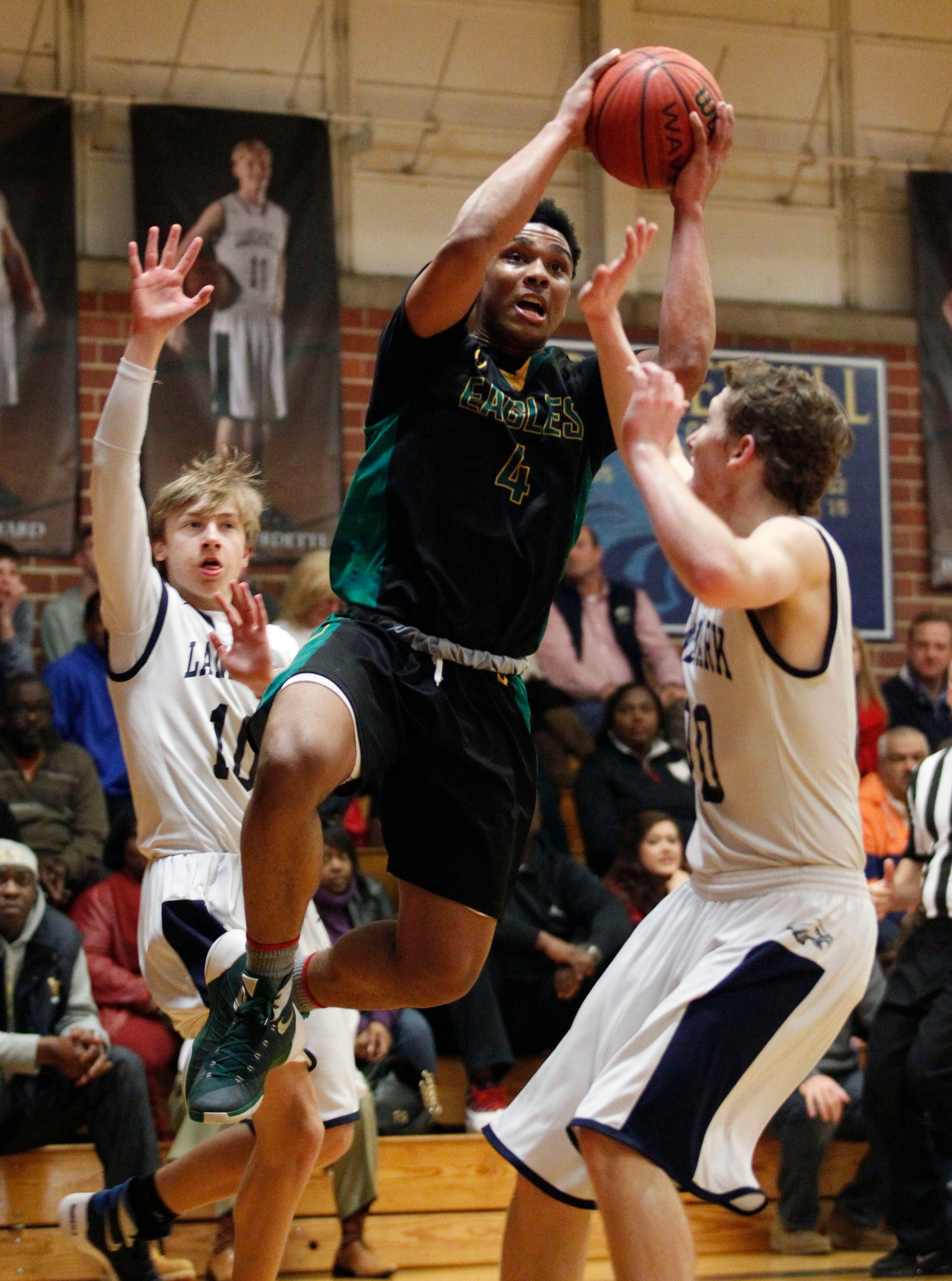 Greenforest Christian Justin Forrest (4) shoots around Landmark Mitchell Riggs (10) and Collier Schultz (00) at a high school basketball game at Landmark Christian school Friday, February 5, 2016. TAMI CHAPPELL/SPECIAL TO THE AJC