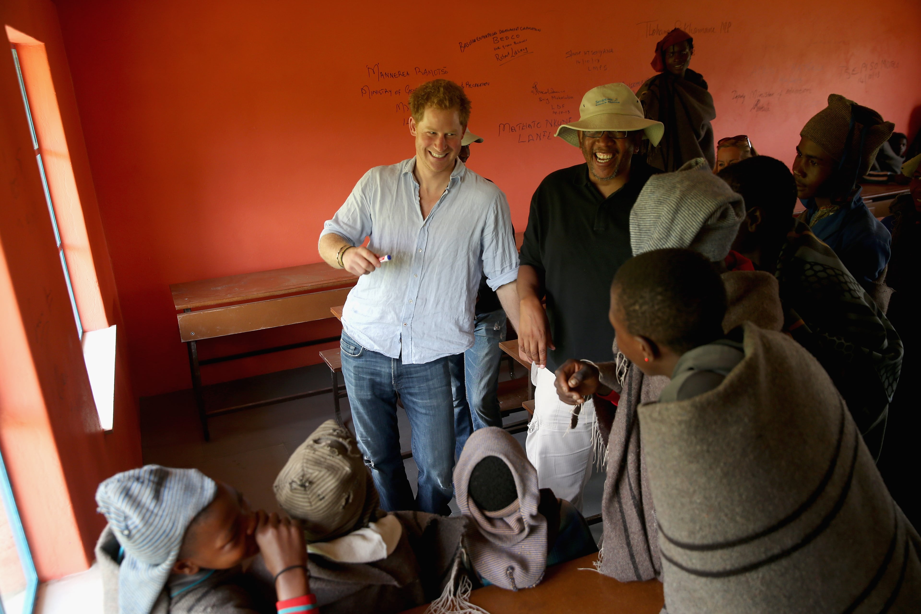Prince Harry and Prince Seeiso of Lesotho share a joke with herd boys during a visit to a herd boy night school constructed by Sentebale on December 8, 2014 in Maseru, Lesotho. Prince Harry was visiting Lesotho to see the work of his charity Sentebale. Sentebale provides healthcare and education to vulnerable children in Lesotho, Southern Africa. The particular theme of his visit was to check on the progress of the Mamohato Childrens Centre which will provide vital support to children affected by HIV. Prince Harry founded Sentebale (which means Forget Me Not in Sesotho) with Prince Seeiso in 2006. (Photo by Chris Jackson/Getty Images for Sentebale)