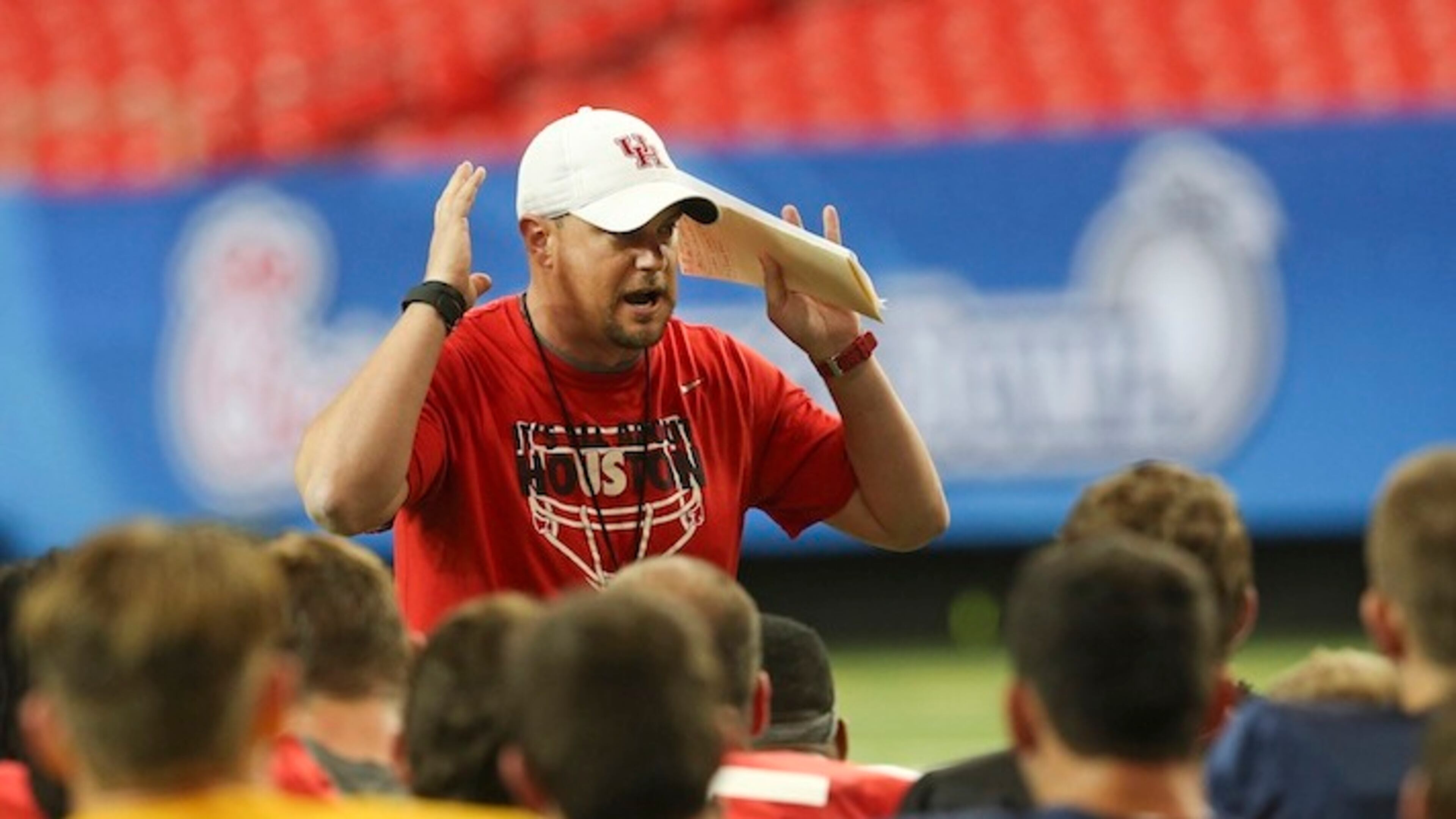 Houston head coach Tom Herman talks to his players during a practice for the Peach Bowl at the Georgia Dome Tuesday, Dec. 29, 2015, in Atlanta. Houston will face Florida State on New Year's Eve. (AP Photo/John Bazemore)
