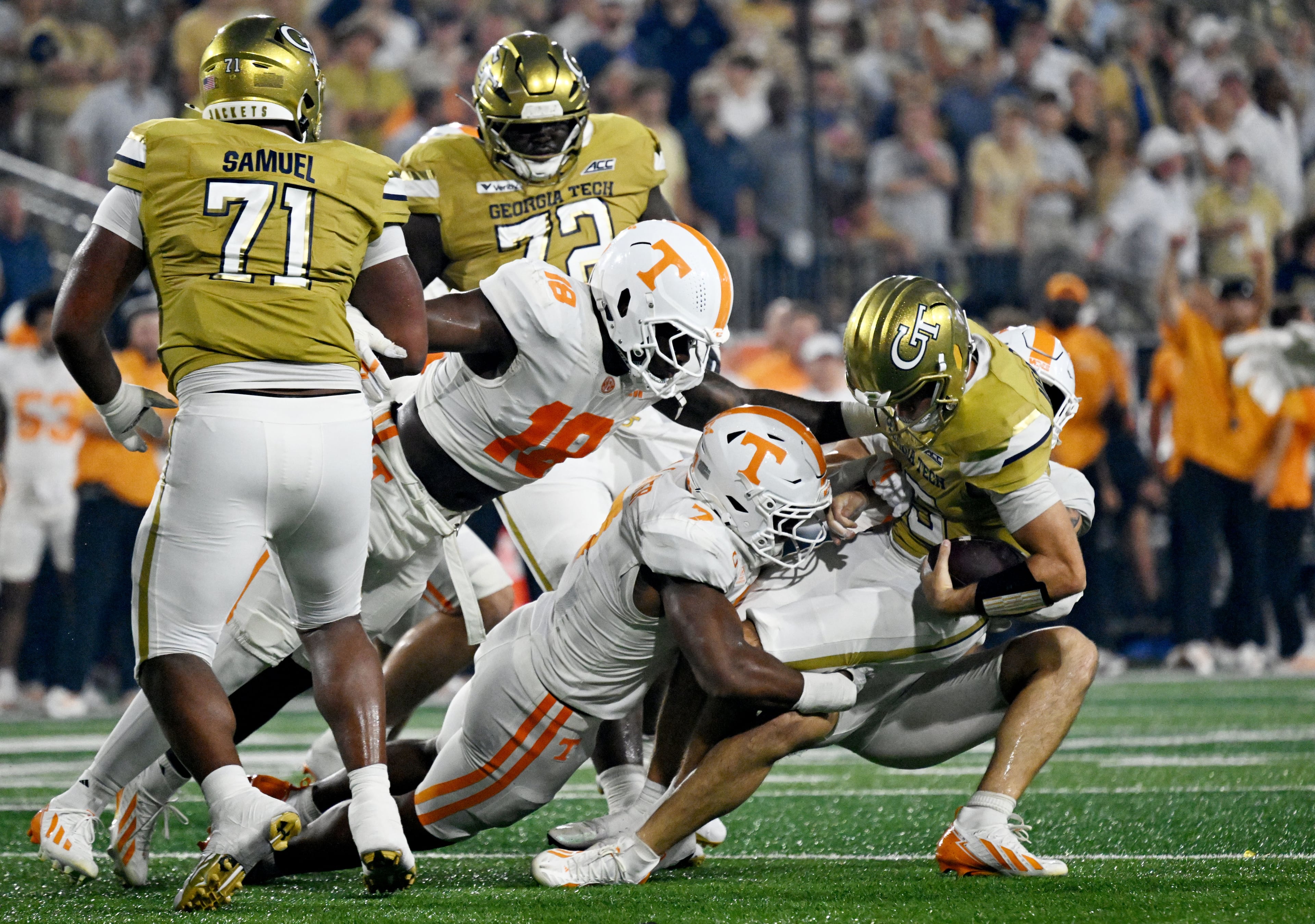 Georgia Tech quarterback Alberto Mendoza (15) is sacked by Tennessee linebacker Arion Carter (7) and Tennessee linebacker Jeremiah Telander (behind) during the second half in an NCAA college football game at Bobby Dodd Stadium on Saturday, Sept. 12, 2026, in Atlanta. Tennessee defeated Georgia Tech 45-24. (Hyosub Shin/AJC)