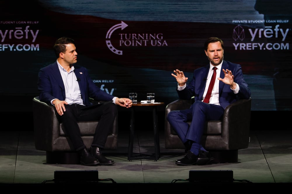 Vice President JD Vance (right), alongside Turning Point USA spokesperson Andrew Kolvet, speaks during an event at Akins Ford Arena in Athens on Tuesday. (Arvin Temkar/AJC)