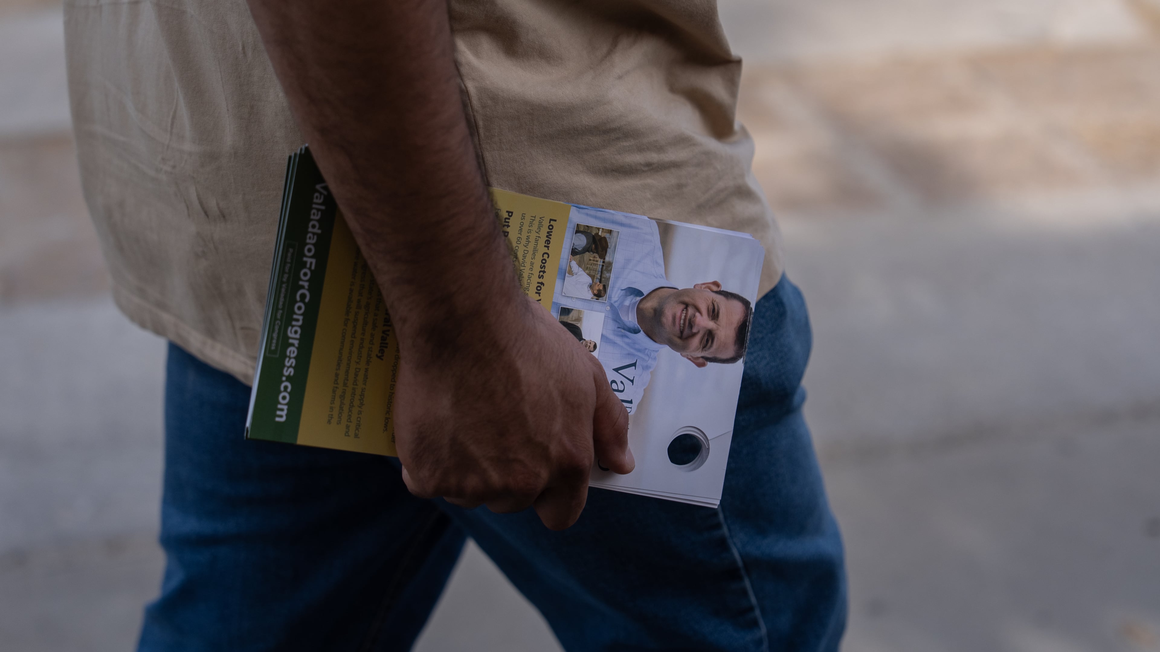 Volunteer Jesus Hernandez carries campaign door hangers while canvassing for U.S. Rep. David Valadao, R-Calif., in Hanford, Calif., Friday, Aug. 21, 2026. (AP Photo/Jae C. Hong)
