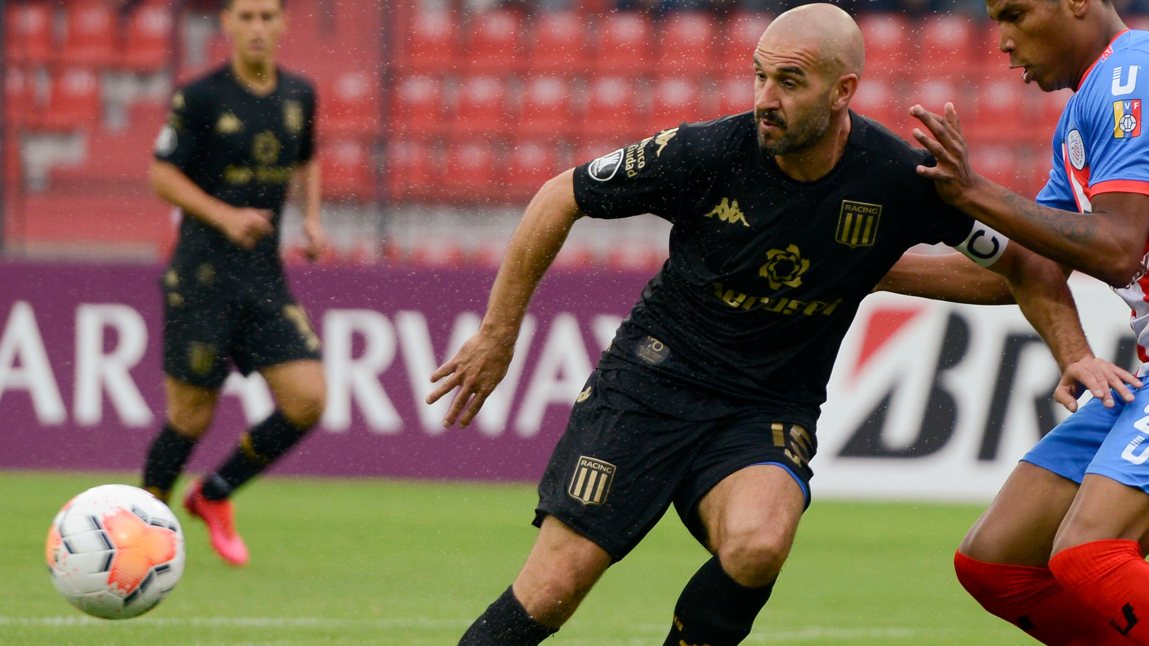 Lisandro Lopez of Argentina's Racing Club, left, and Edison Penilla of Venezuela's Estudiantes de Merida battle for the ball during a Copa Libertadores soccer match March 5, 2020, in Merida, Venezuela. (Matias Delacroix/AP)