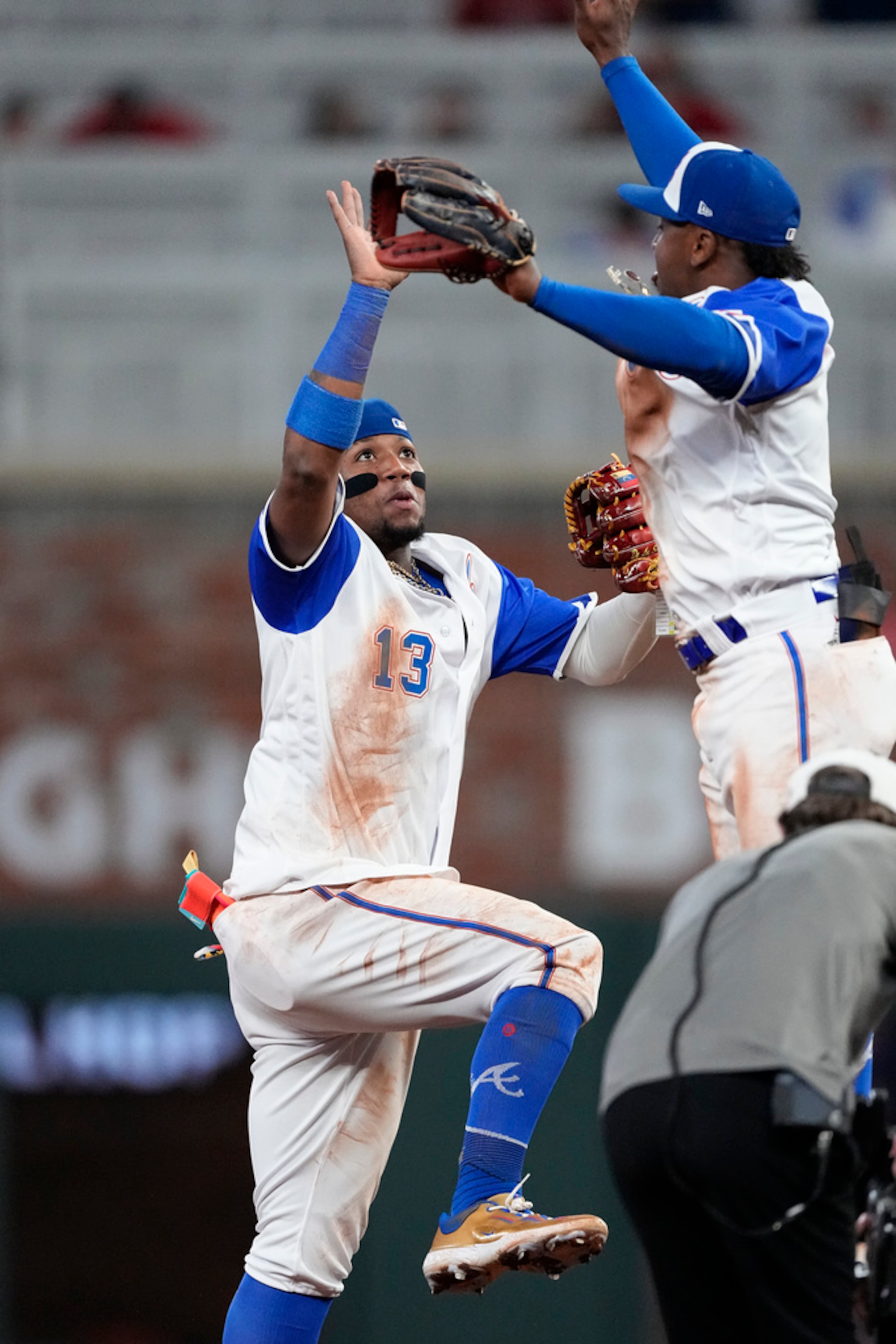 Atlanta Braves right fielder Ronald Acuna Jr. (13) and second baseman Ozzie Albies (1) celebrate after defeating the Baltimore Orioles in a baseball game Saturday, May 6, 2023, in Atlanta. (AP Photo/John Bazemore)