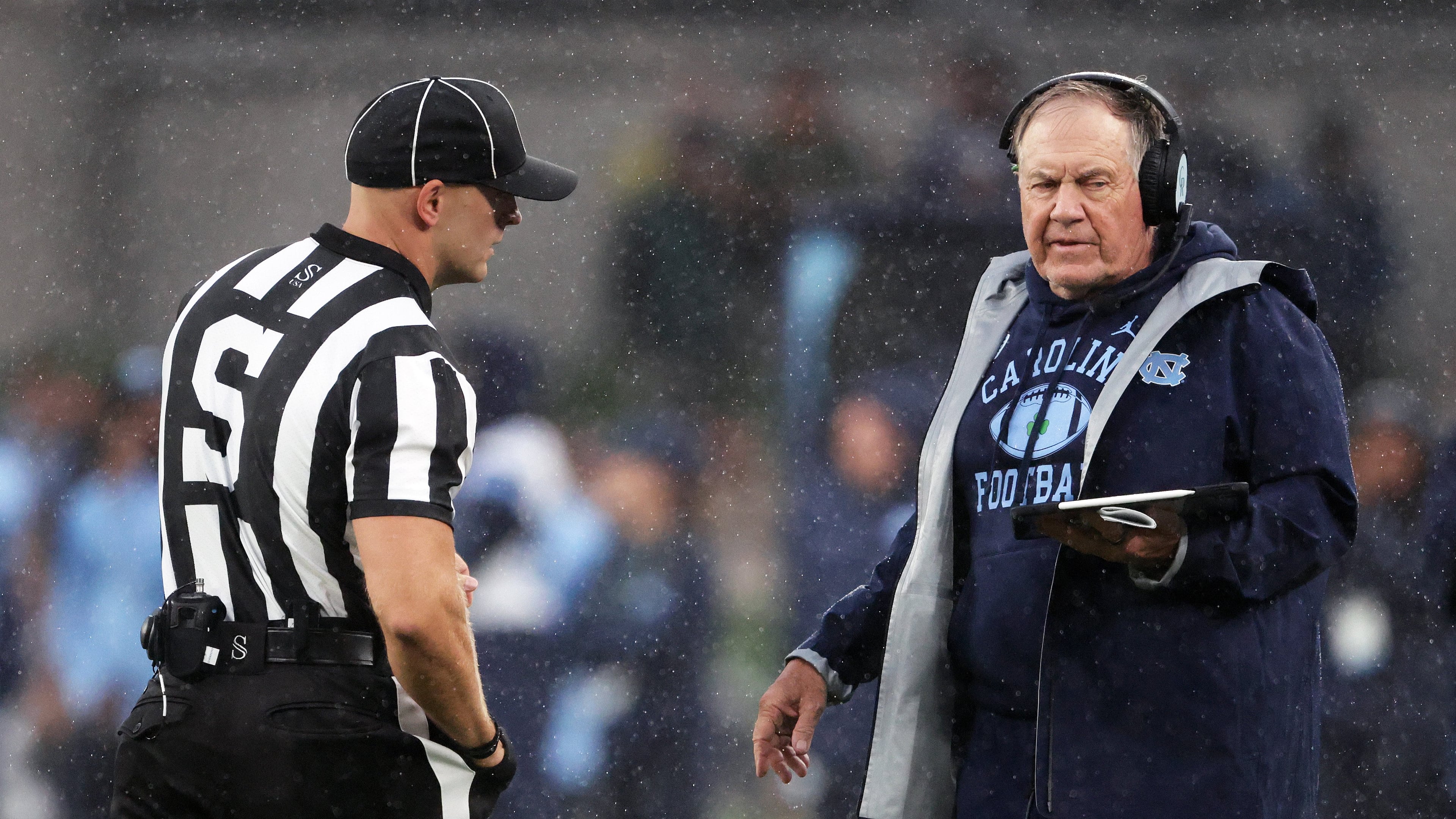 North Carolina head coach Bill Belichick, right, speaks with an official during an NCAA college football game against TCU in Dublin, Ireland, Saturday, Aug. 29, 2026. (AP Photo/Peter Morrison)