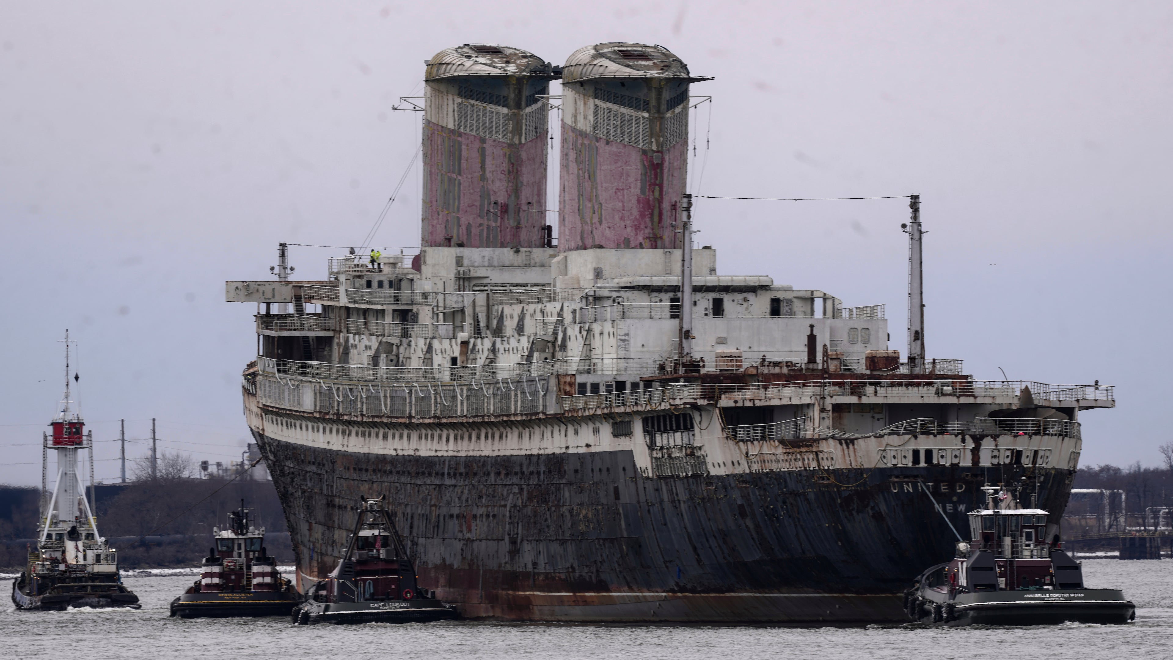 FILE - The SS United States is towed down the Delaware River between Pennsylvania and New Jersey, from Philadelphia, Wednesday, Feb. 19, 2025. (AP Photo/Matt Rourke, File)