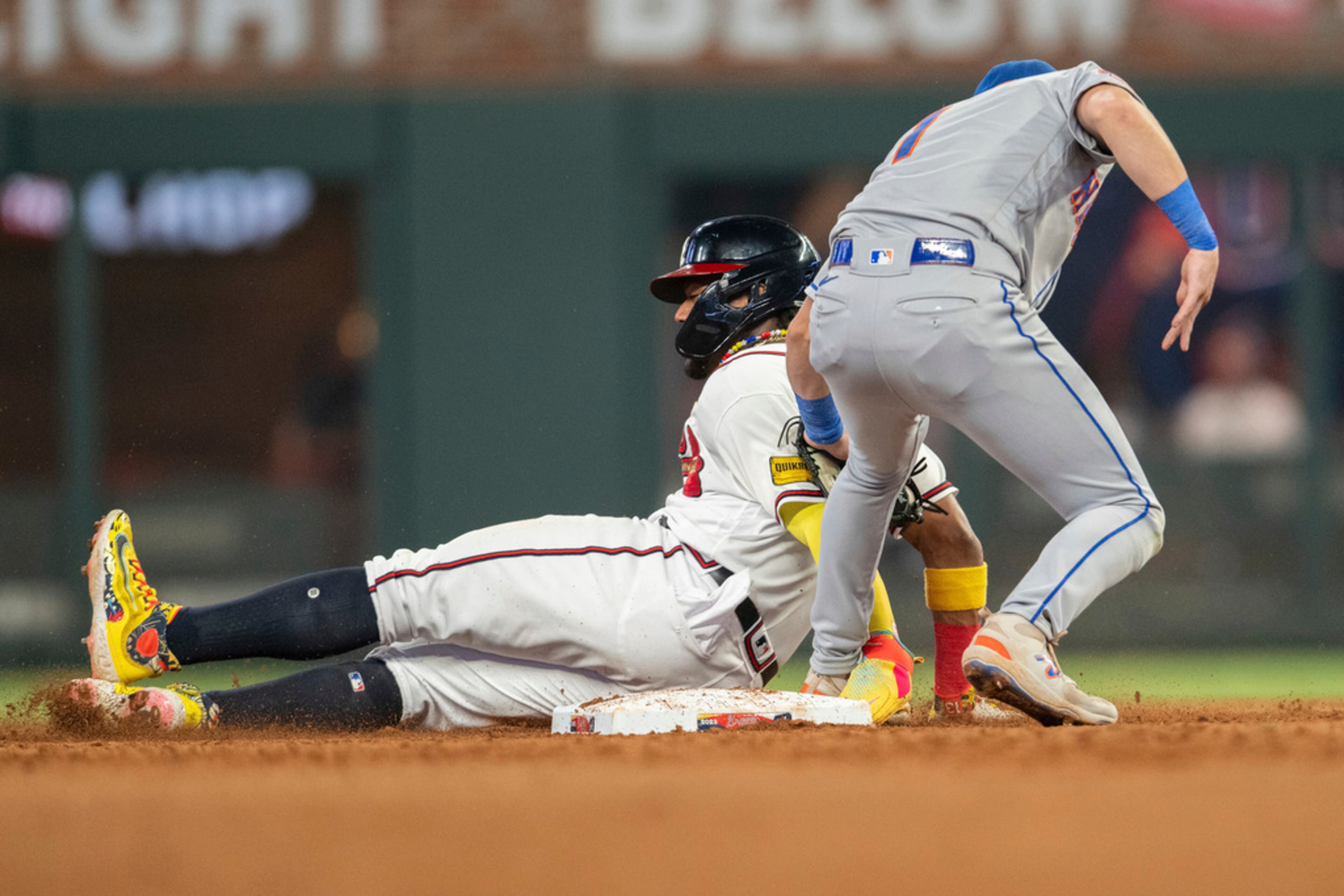 New York Mets second baseman Jeff McNeil tags Atlanta Braves' Ronald Acuna Jr. in the fifth inning of a baseball game, Wednesday, Aug. 23, 2023, in Atlanta. (AP Photo/Hakim Wright Sr.)