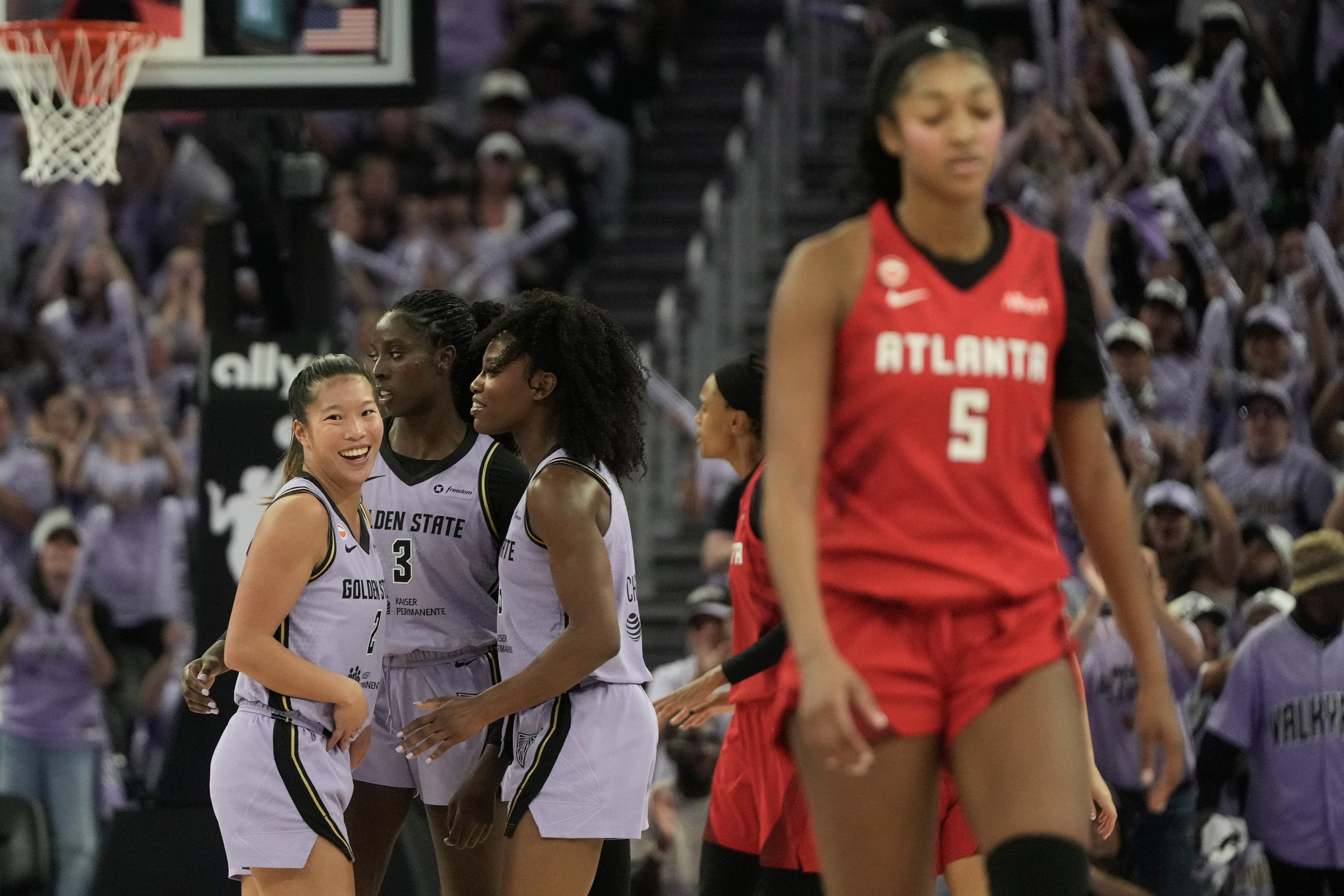 Valkyries players celebrate while the Dream's Angel Reese heads to the bench in Game 1. (Jeff Chiu/AP)
