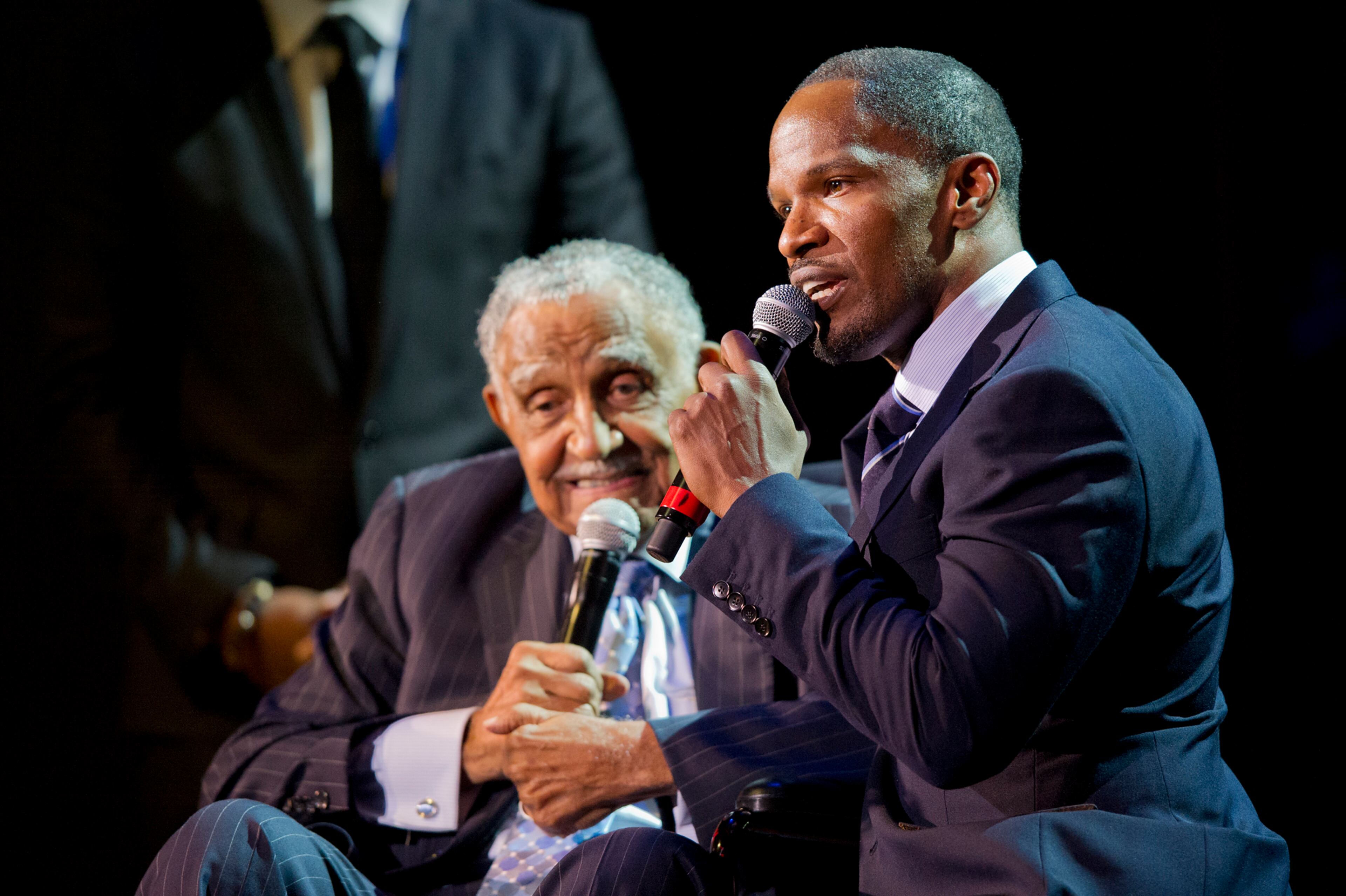Actor Jamie Foxx (right) kneels next to Rev. Dr. Joseph E. Lowery during a tribute to Lowery on his 92nd birthday in 2013.JONATHAN PHILLIPS / SPECIAL