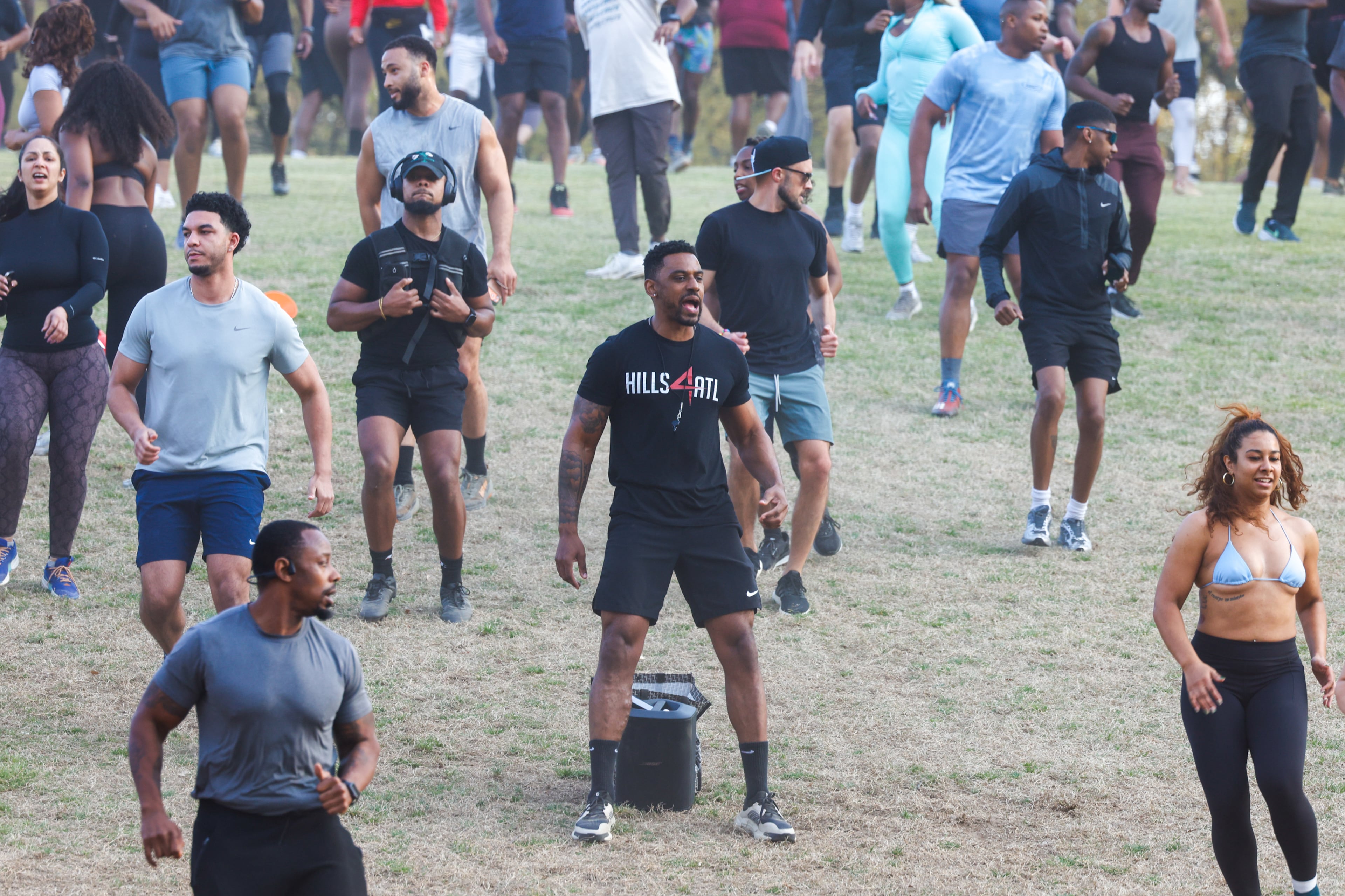 Alvin Bailey (center) leads the Hills4ATL fitness group exercise event at Piedmont Park in Atlanta on March 25, 2026. (Arvin Temkar/AJC)