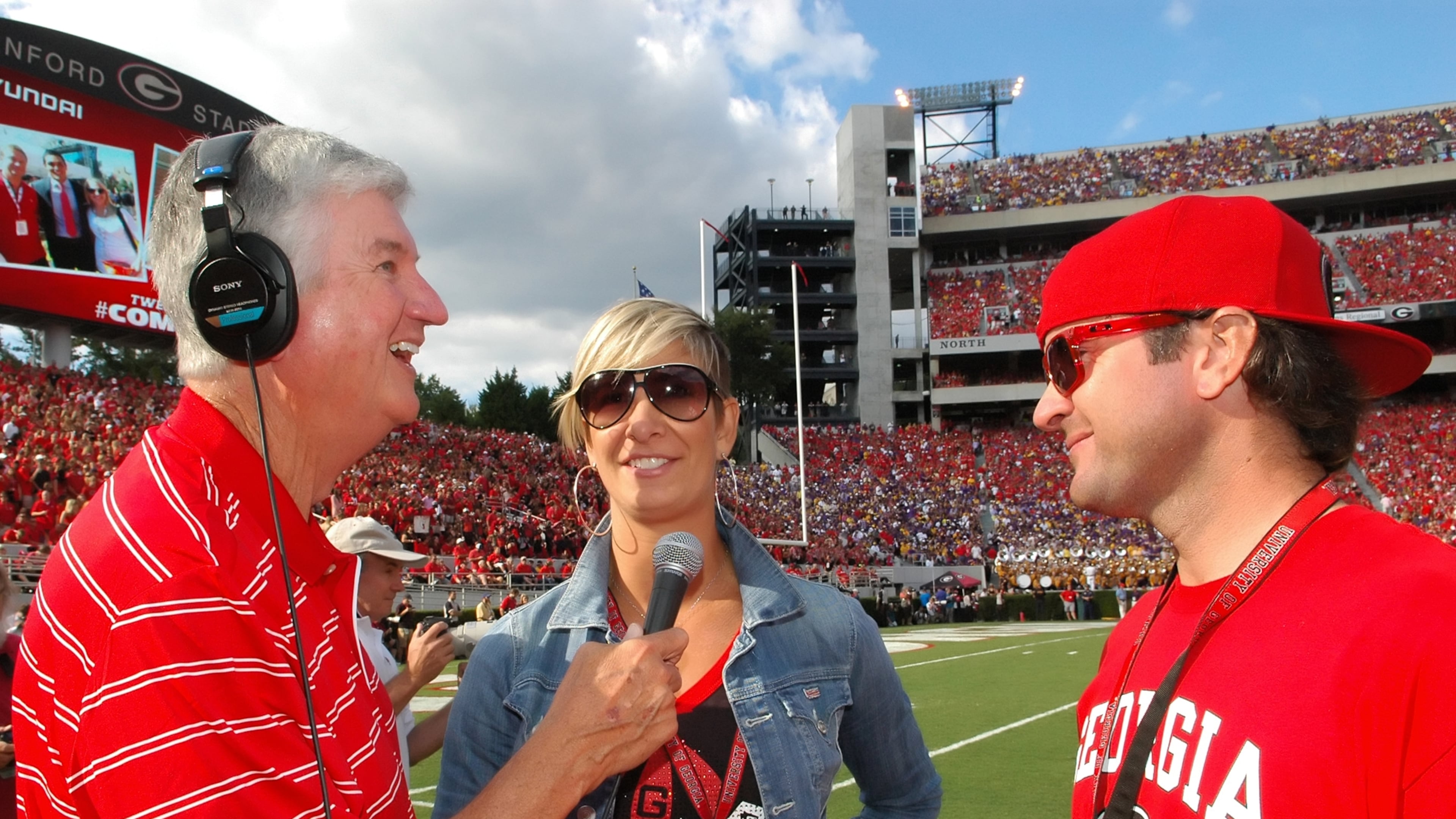 Chuck Dowdle interviews PGA golfer Bubba Watson (right) and his wife, Angie Ball Watson (center). Bubba Watson played golf at Georgia, and Angie Ball Watson played for the Georgia Lady Bulldogs basketball team. (Photo by Dan Evans/UGA)