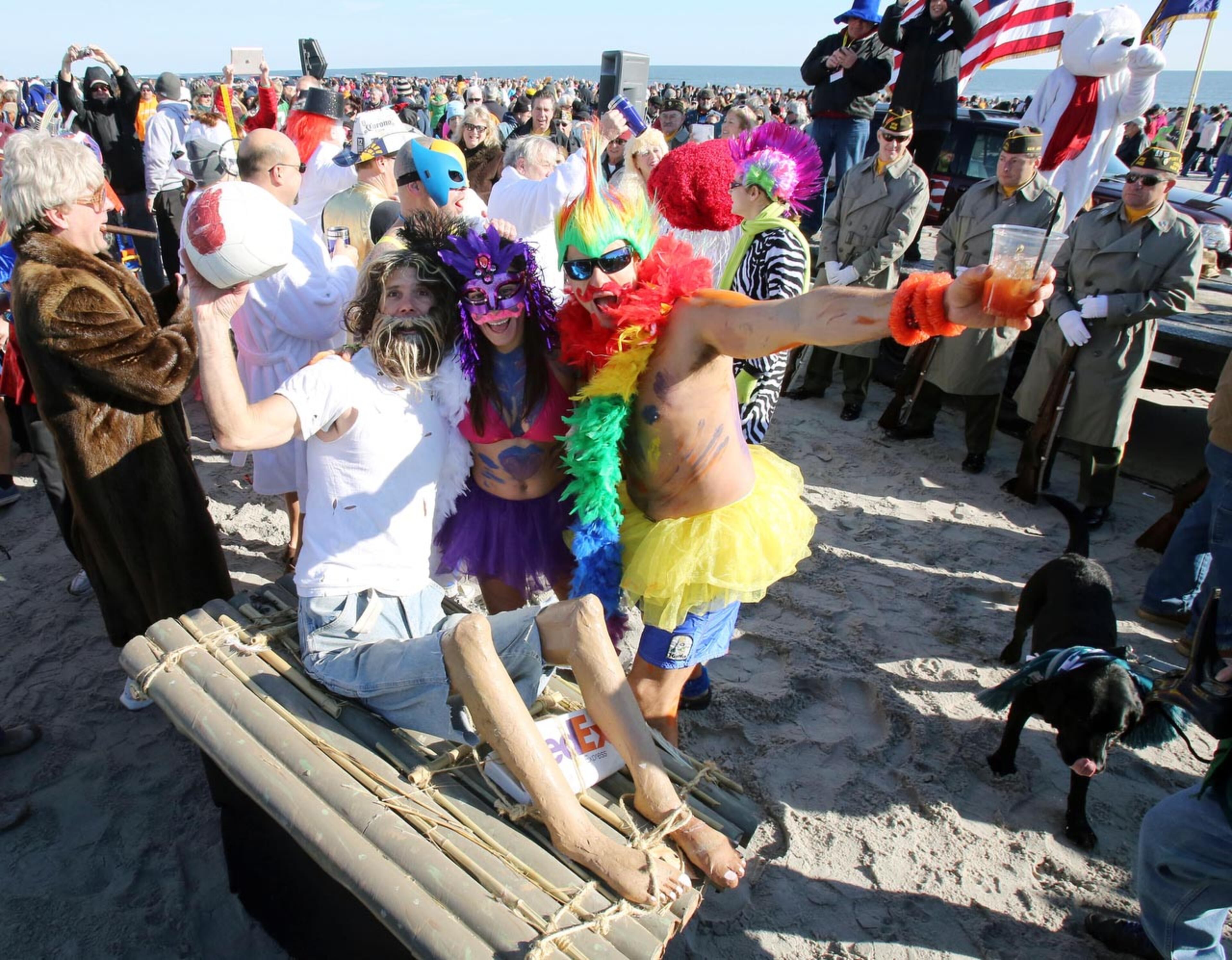 Polar bear plungers Mike Kuharik of Smithville, left, Kira Dougherty of Galloway, and Sven Peltonen of Brigantine, get ready to take a dip in the Atlantic Ocean at 12th Street in Brigantine, N.J., Wednesday Jan 1, 2014. Brigantine held it's annual New Year's Day polar bear plunge to start off the new year with hundreds of participants taking part in the event by running into the icy Atlantic Ocean to kick off 2014. (AP Photo/Press of Atlantic City, Dale Gerhard)