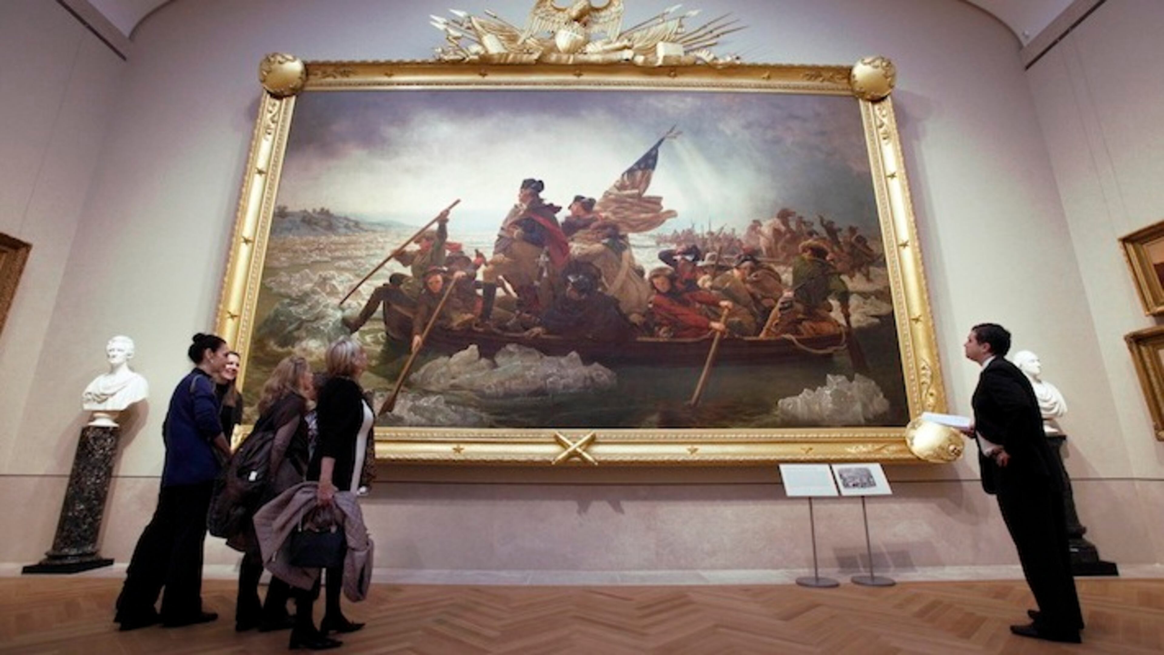 In this Jan. 12, 2012 photo, visitors to the American Wing of the Metropolitan Museum of Art, in New York, view “Washington Crossing the Delaware,” by Emanuel Gottlieb Leutze. When the Metropolitan Museum of Art opens its dramatic new American Wing Galleries for Paintings, Sculpture and Decorative Arts this month, treasures from the 18th to the early 20th century are bound to captivate the public as never before. (AP Photo/Richard Drew)