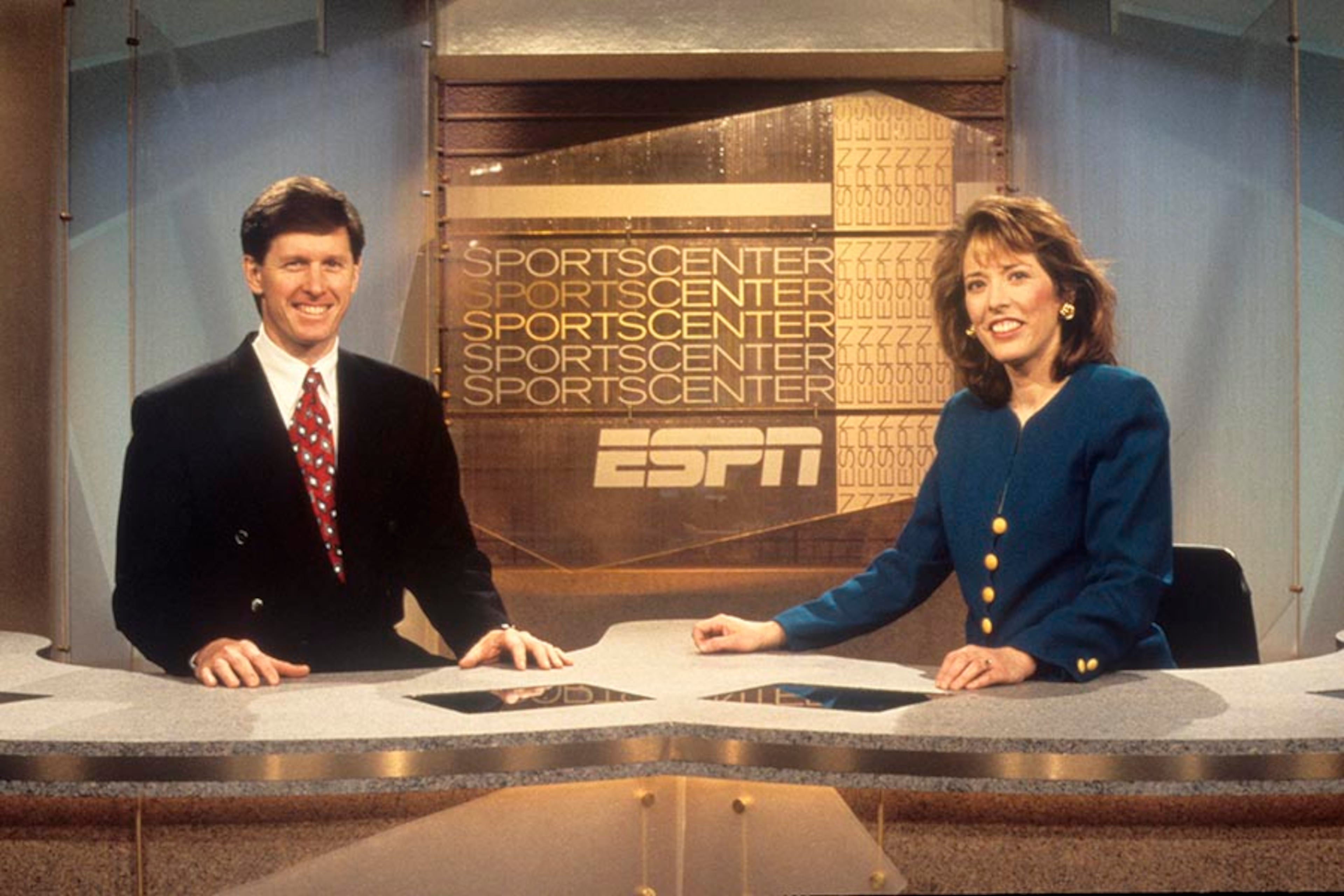 SportsCenter hosts Jack Edwards and Linda Cohn are shown posing for a promotional photo on the studio set. The tagline "This is SportsCenter" is introduced to the masses.