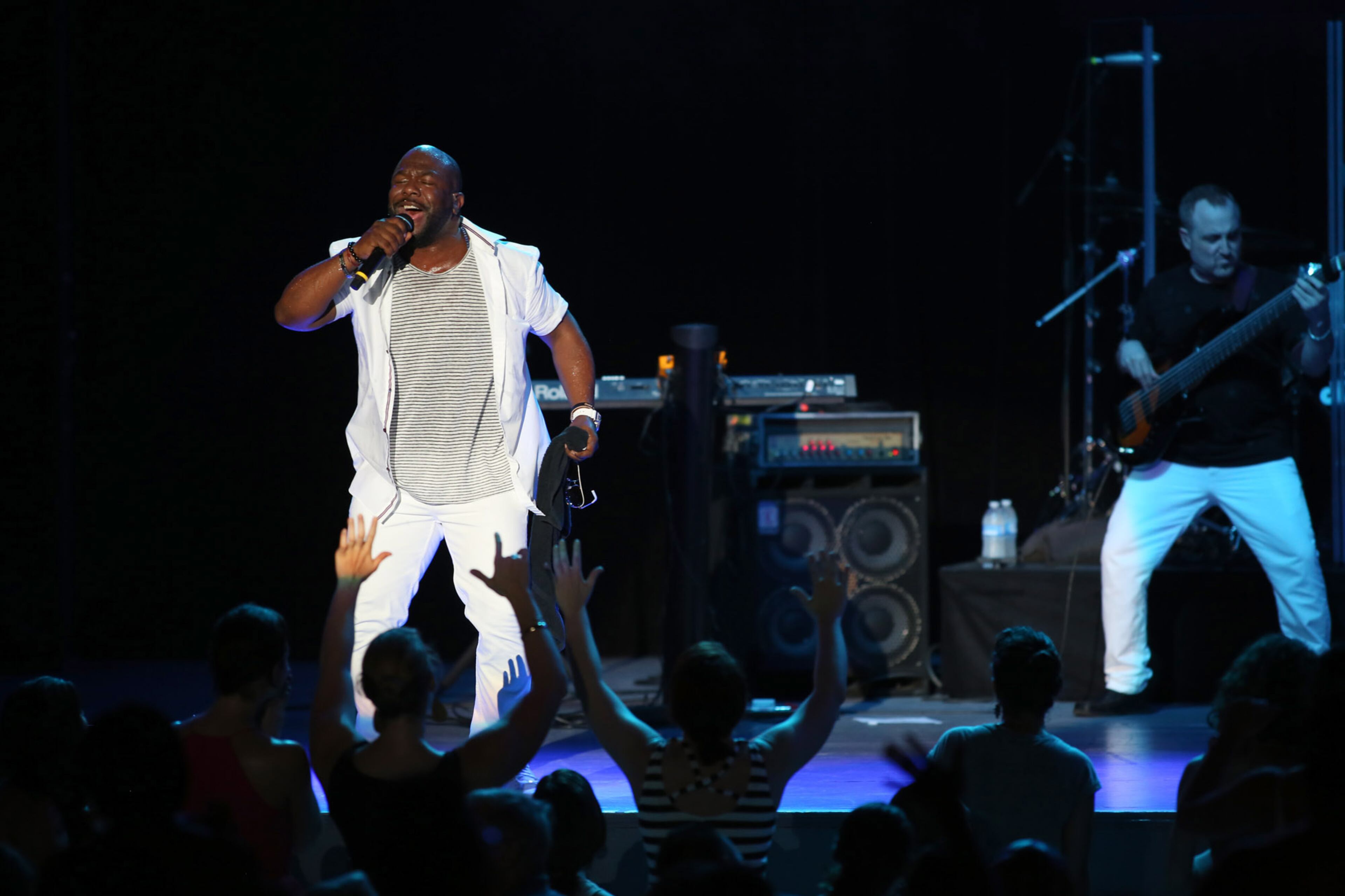 Boy II Men's Wanya Morris, known for his vibrato-heavy tenor, croons to the audience their iconic hit "On Bended Knee," to an enthusiastic audience at Chastain Amphitheatre Friday.