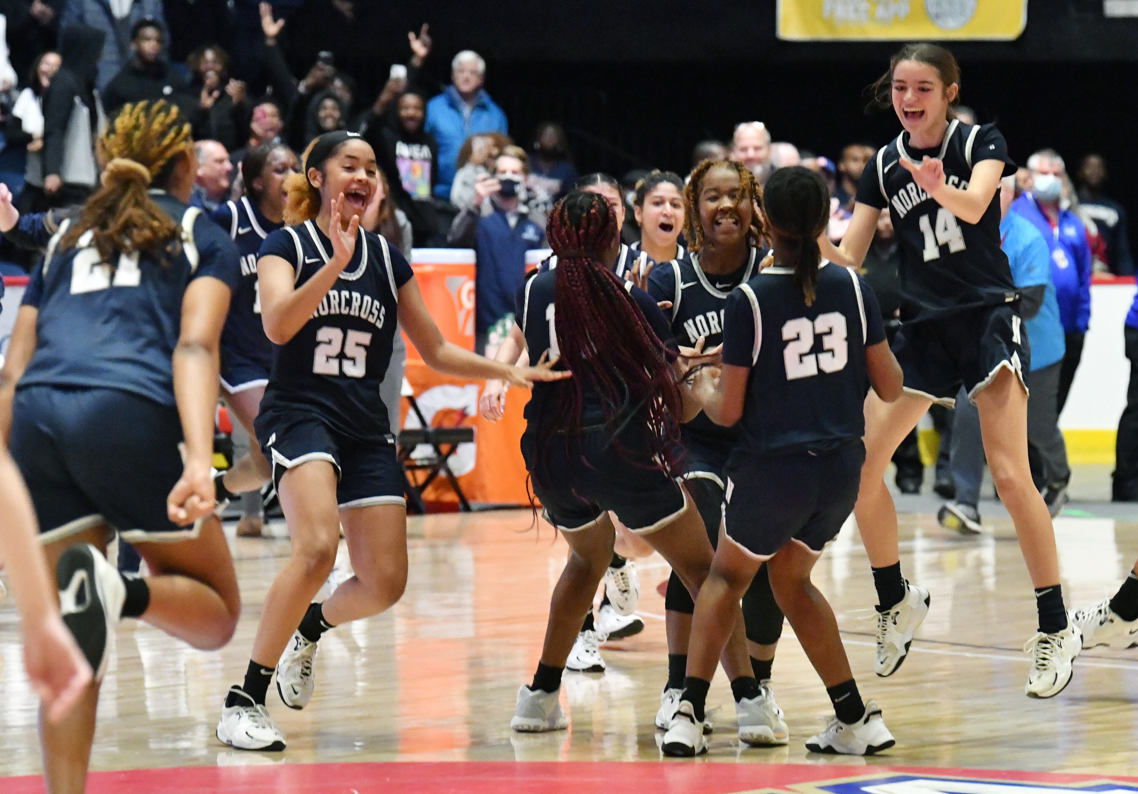 Norcross players celebrate their victory over Harrison during the 2022 GHSA State Basketball Class AAAAAAA Girls Championship game at the Macon Centreplex in Macon on Saturday, March 12, 2022. Norcross won 41-37 over Harrison. (Hyosub Shin / Hyosub.Shin@ajc.com)