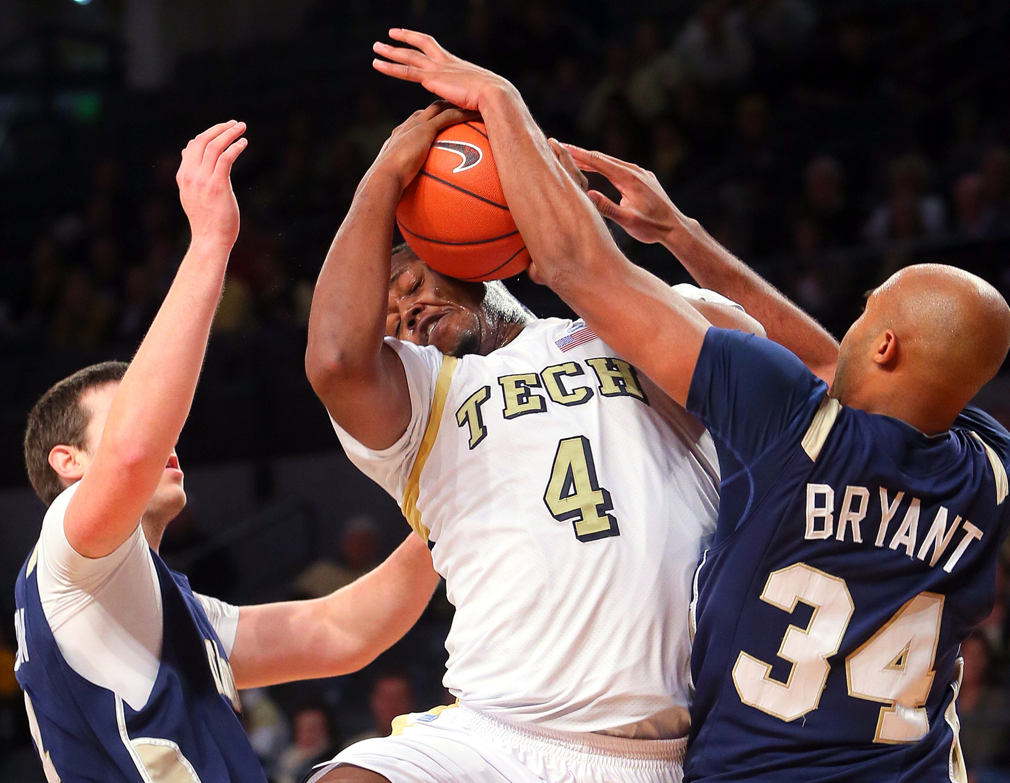 Georgia Tech forward Marcus Carter, Jr., is blocked by Chattanooga Mocs forward Jared Bryant on his way to the basket during 1st half action at McCamish Pavilion in Atlanta on Wednesday, Jan. 2, 2013. CURTIS COMPTON / CCOMPTON@AJC.COM
