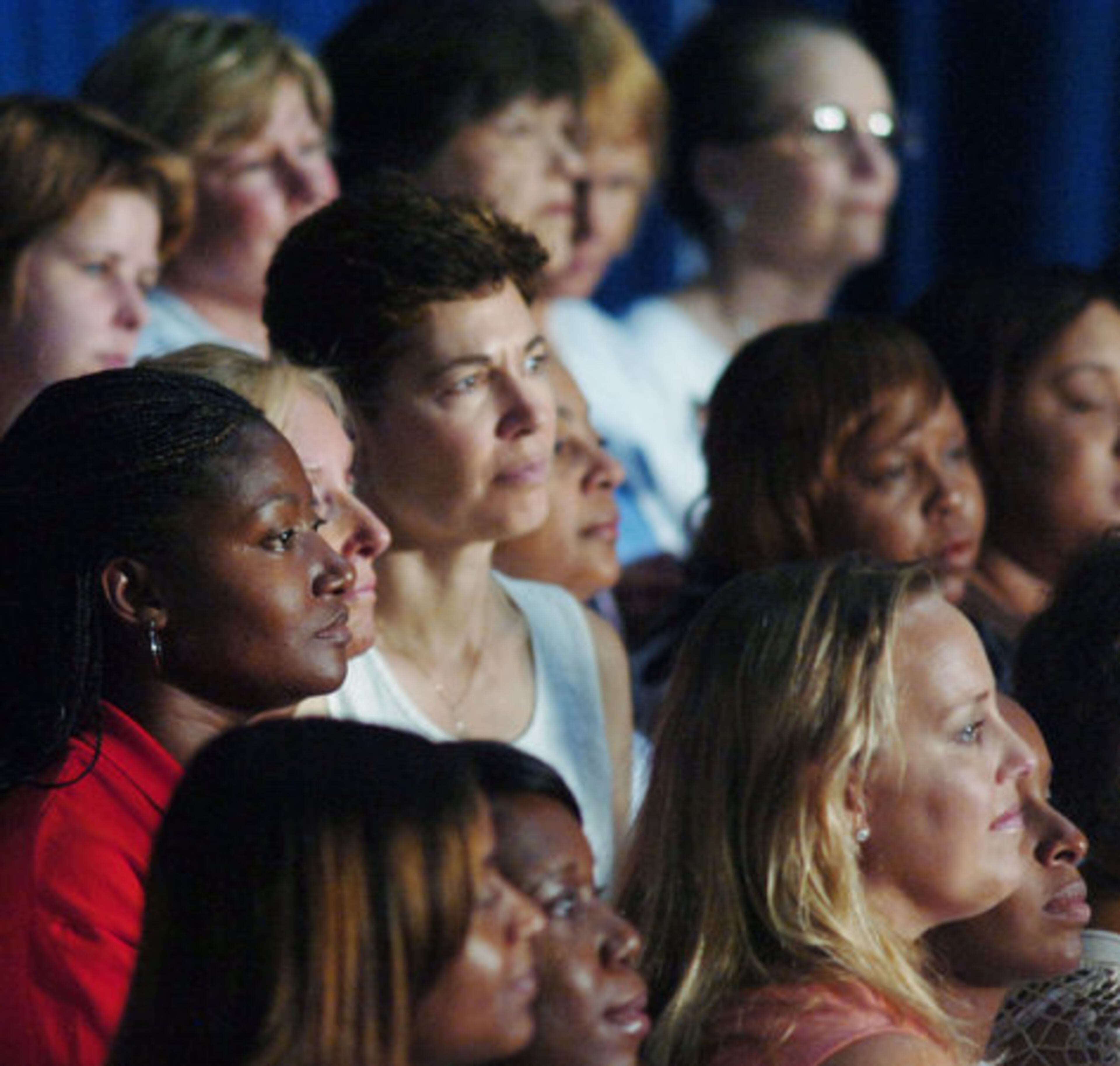 Alisha Thomas Morgan (in red blouse at left), a Democrat and member of the Georgia Legislature representing Cobb County, joins others in listening to Obama speak.