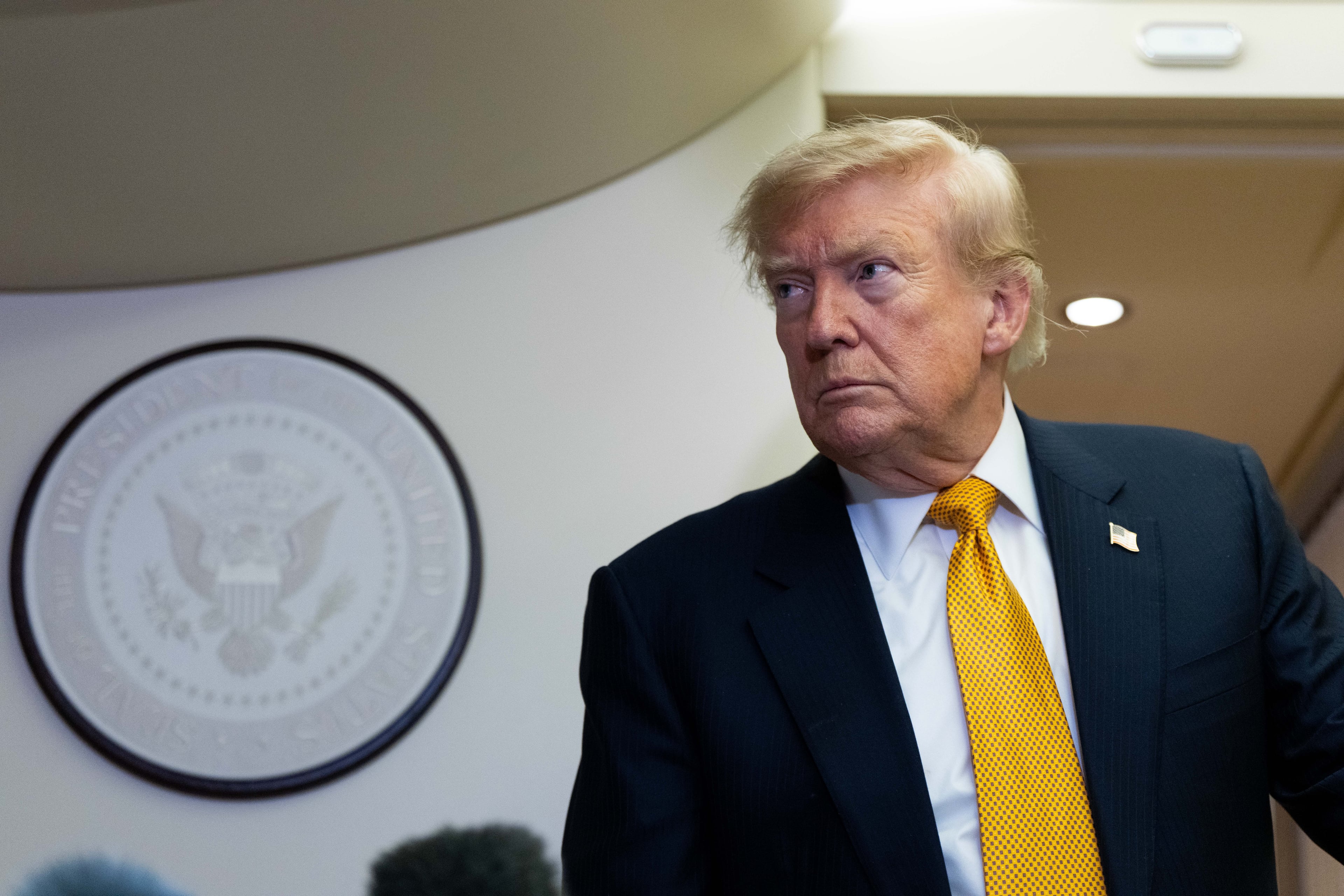 President Donald Trump speaks with reporters on Air Force One last week. (Alex Brandon/AP)