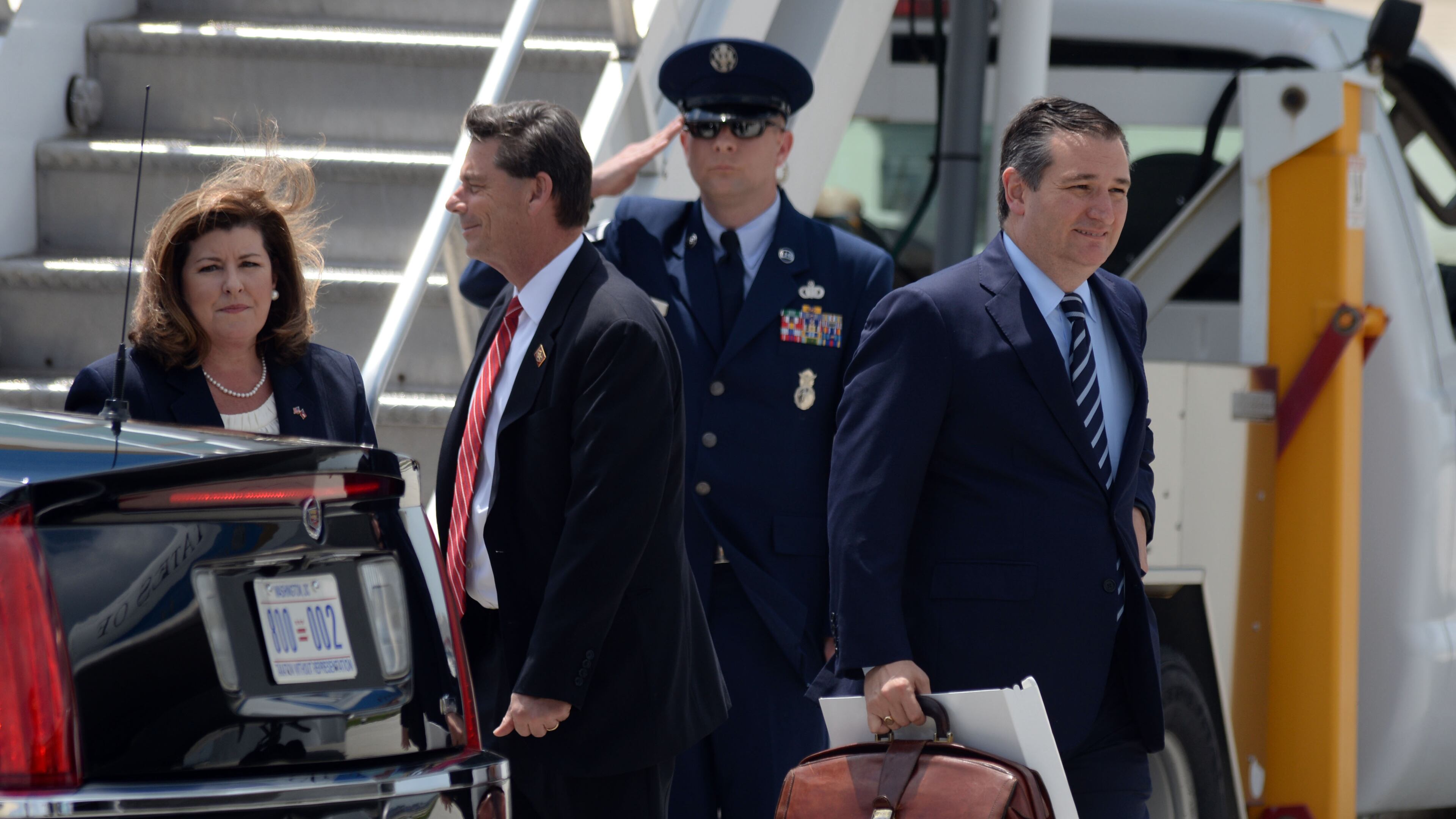 GOP congressional candidate Karen Handel walks towards the presidential limo as U.S. Sen.Ted Cruz, heads for another vehicle in the motorcade as President Donald Trump arrives at Hartsfield Jackson International Airport aboard Air Force One on Friday. Kent D. Johnson, kdjohnson@ajc.com