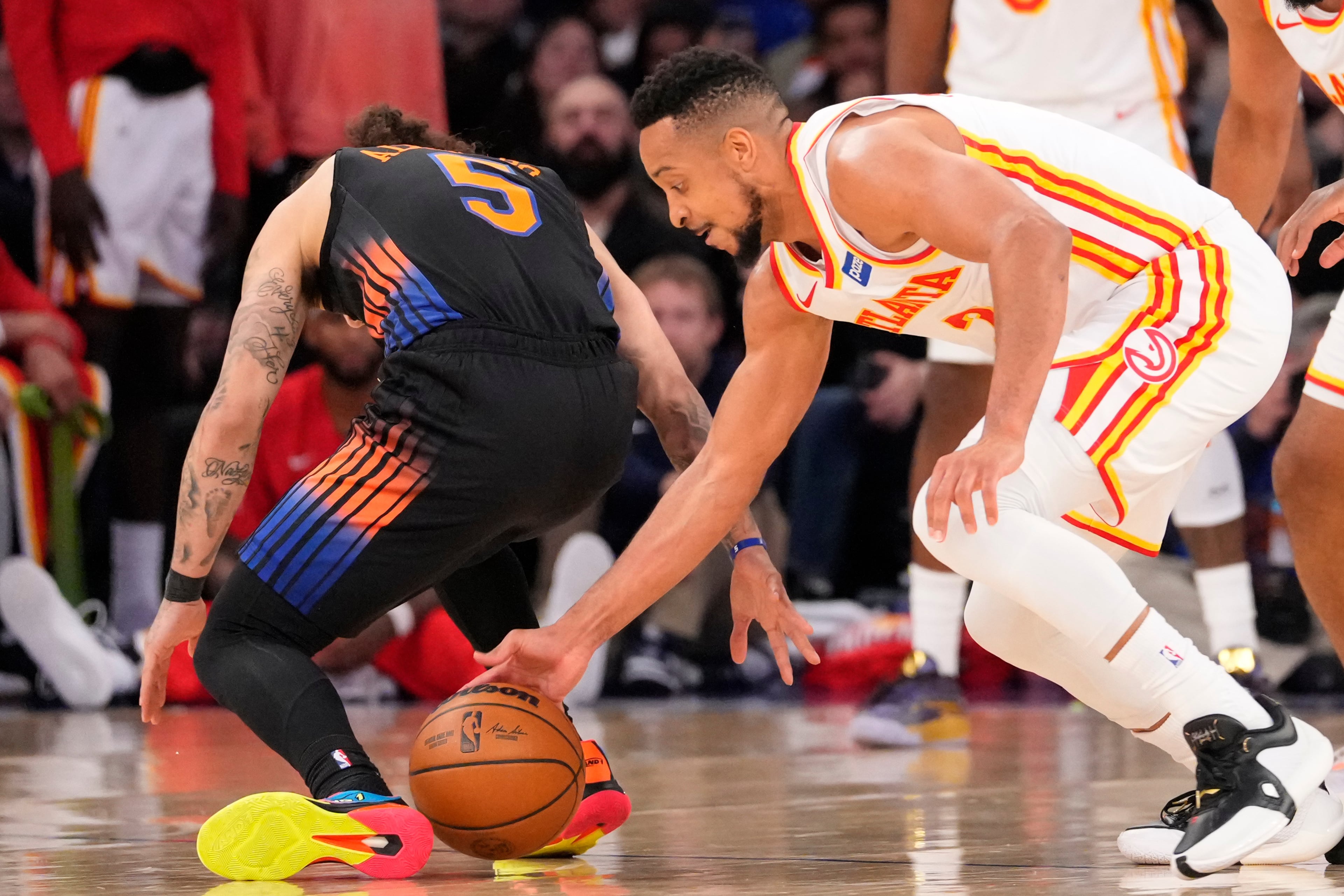 Hawks guard CJ McCollum (right) attempts to steal the ball from Knicks guard Jose Alvarado during Game 2 of a first-round NBA playoffs basketball series on Monday, April 20, 2026, in New York. (Yuki Iwamura/AP)