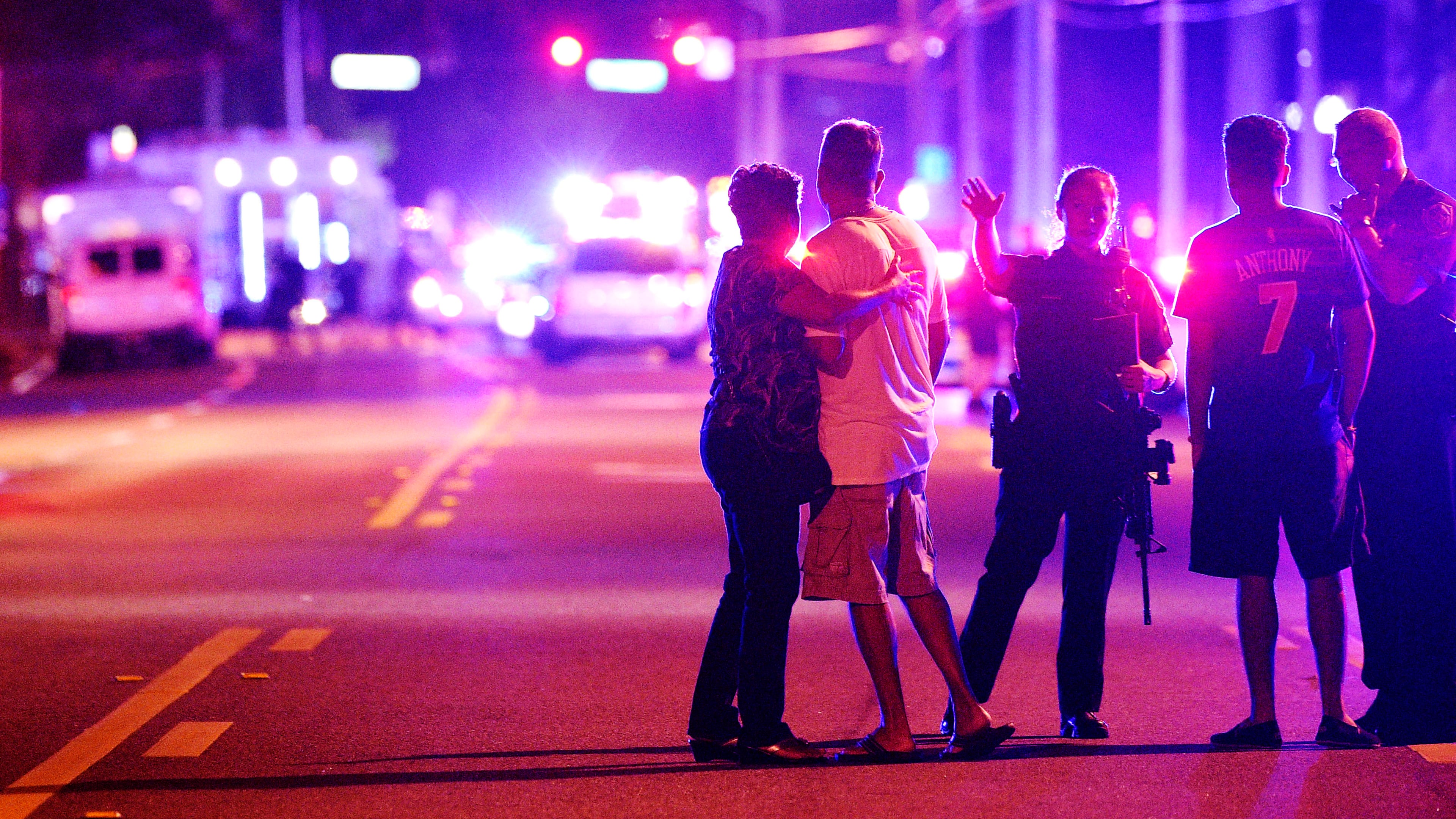 2016 AP YEAR END PHOTOS - Orlando Police officers direct family members away from a fatal shooting at Pulse nightclub in Orlando, Fla., on June 12, 2016. Omar Mateen, a 29-year-old security guard, killed 49 people and wounded 53 others in the mass shooting. (AP Photo/Phelan M. Ebenhack, File)