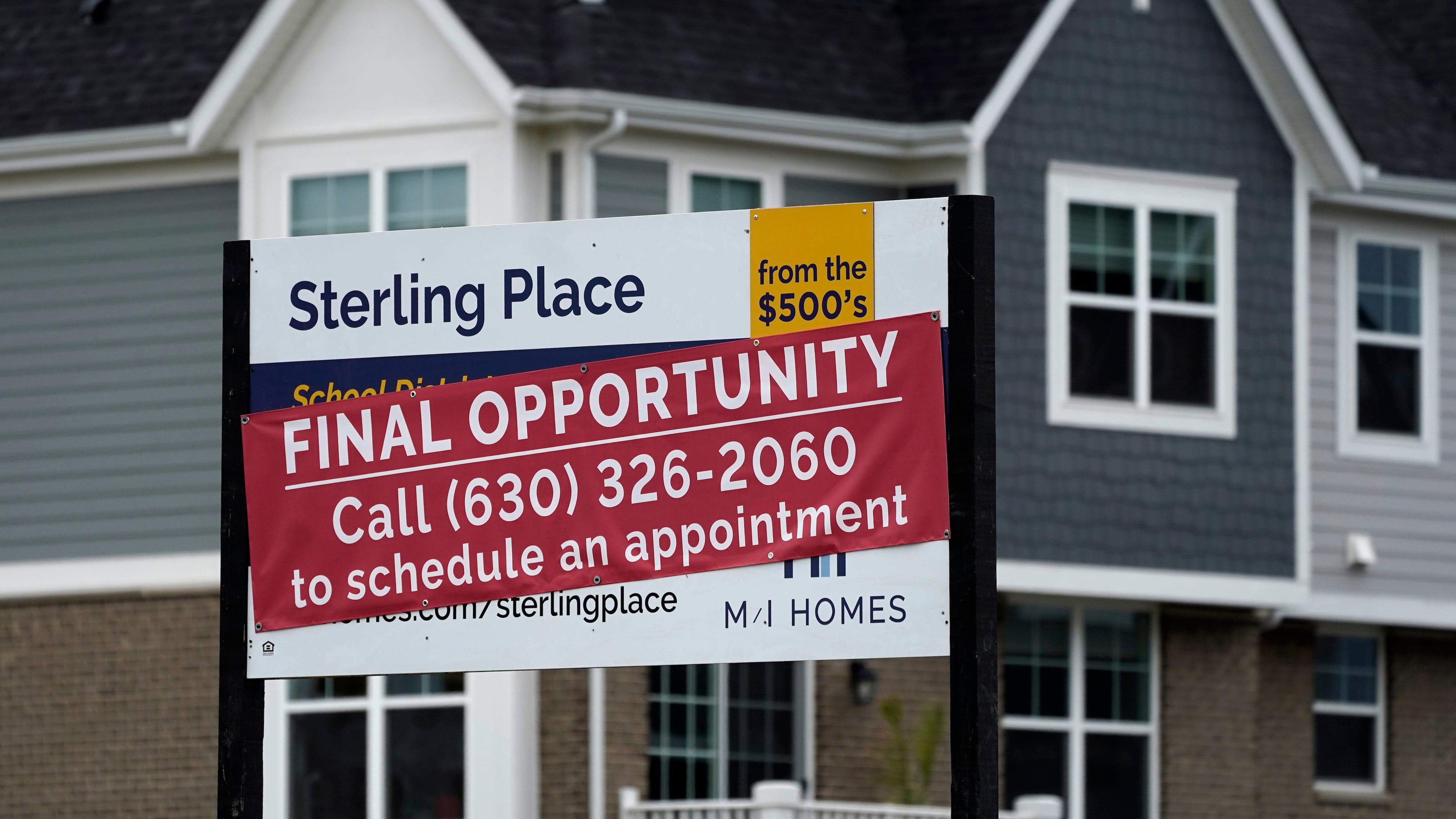 FILE - An advertising sign for building land stands in front of a new home construction site in Northbrook, Ill., on May 5, 2022. (AP Photo/Nam Y. Huh, File)