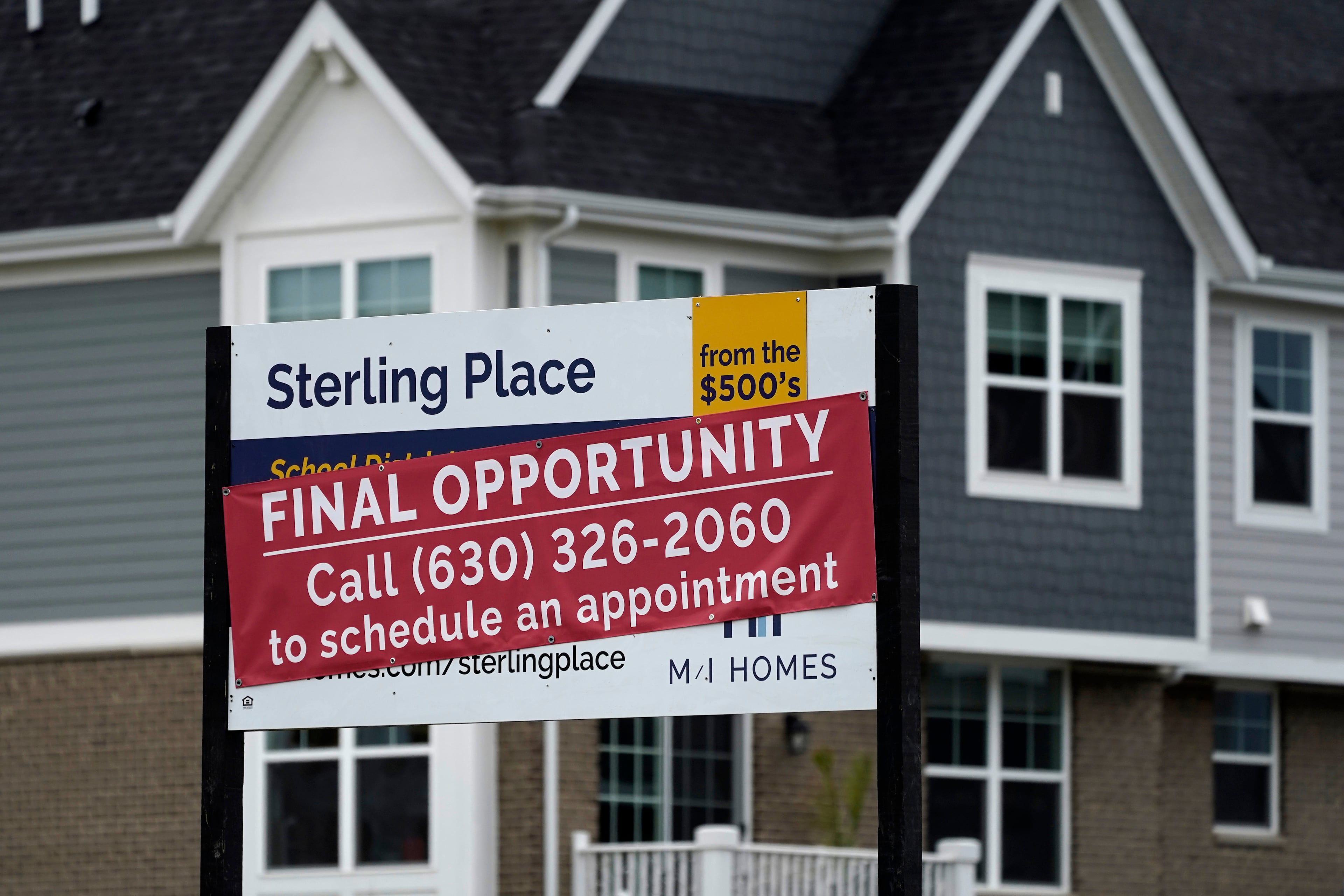 An advertising sign for building land stands in front of a new home construction site in Northbrook, Illinois, in 2022. (Nam Y. Huh/AP)