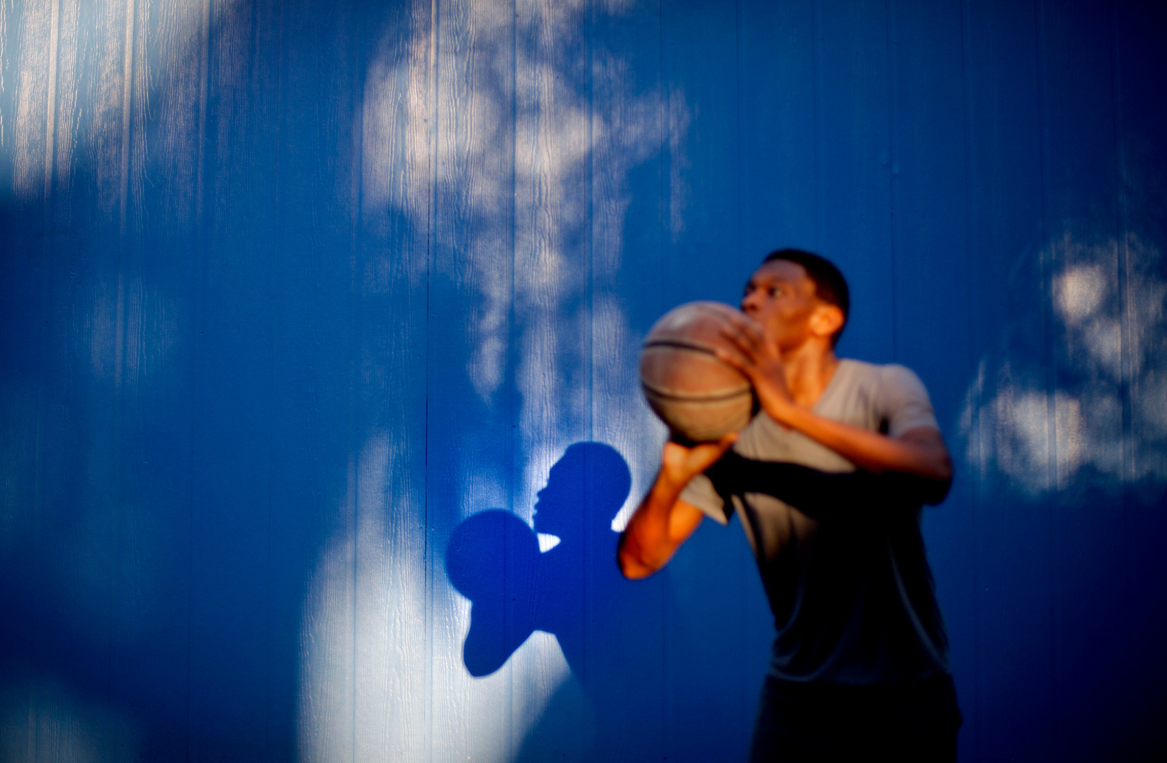 Marvin Grovner, 16, plays with a basketball after returning home to the Hog Hammock community of Sapelo Island, Ga. from school on the mainland on Wednesday, May 15, 2013. Grovner is one of 47 residents, most of them descendants of West African slaves known as Geechee, who remain on the coastal Georgia island where their ancestors were brought to work on a plantation in the early 1800s.