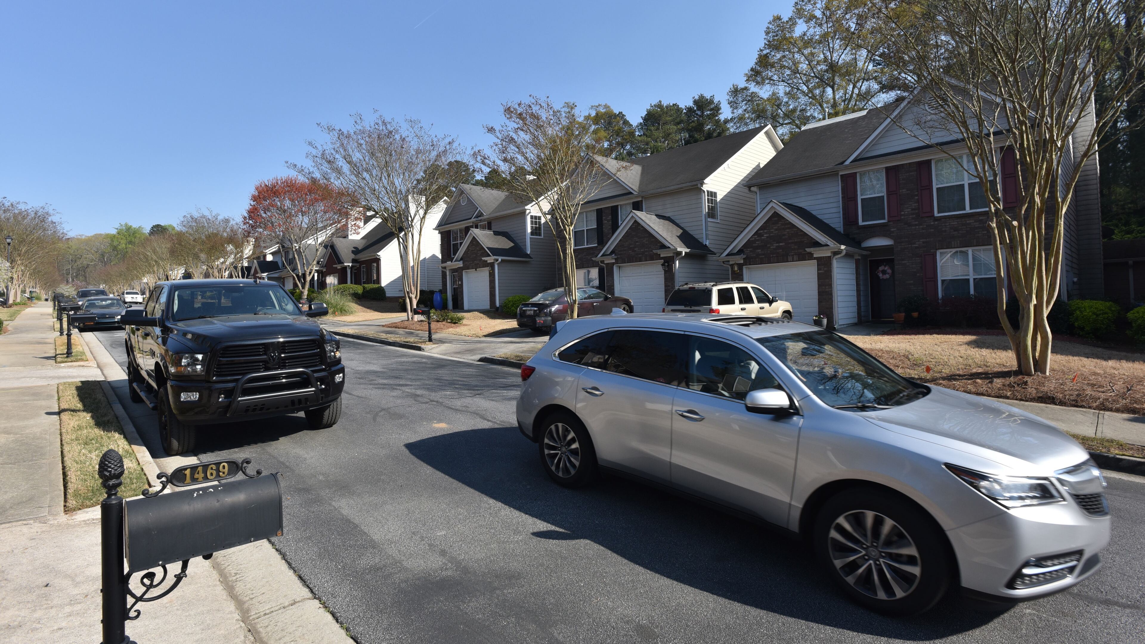 A car drives through The Gates at Bouldercrest subdivision earlier this year. DeKalb officials said they get complaints from neighbors in residential areas over loud noises. HYOSUB SHIN / HSHIN@AJC.COM