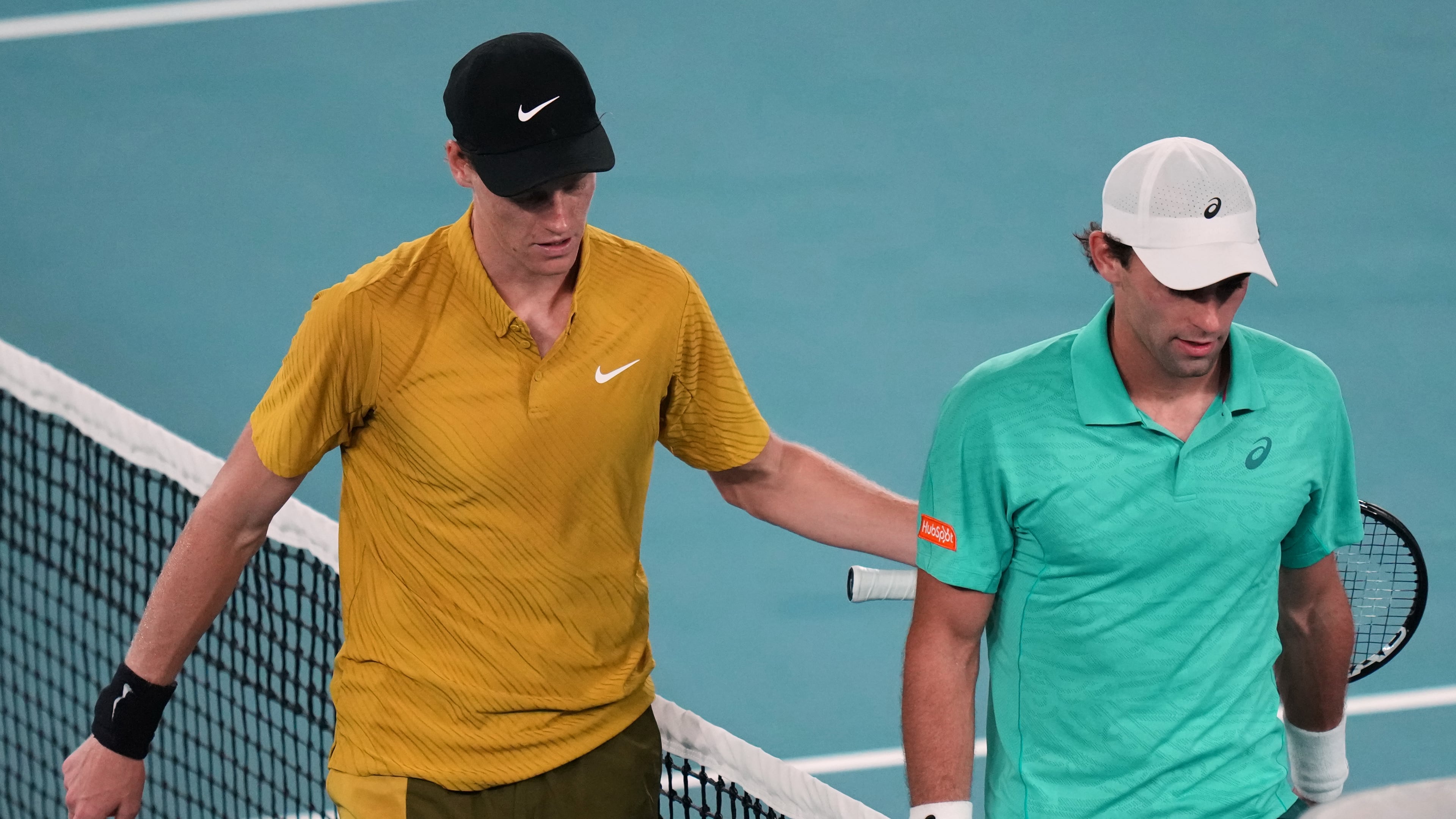 Jannik Sinner, left, of Italy walks from the court with Eliot Spizzirri of the U.S. after winning their third round match at the Australian Open tennis championship in Melbourne, Australia, Saturday, Jan. 24, 2026. (AP Photo/Dar Yasin)
