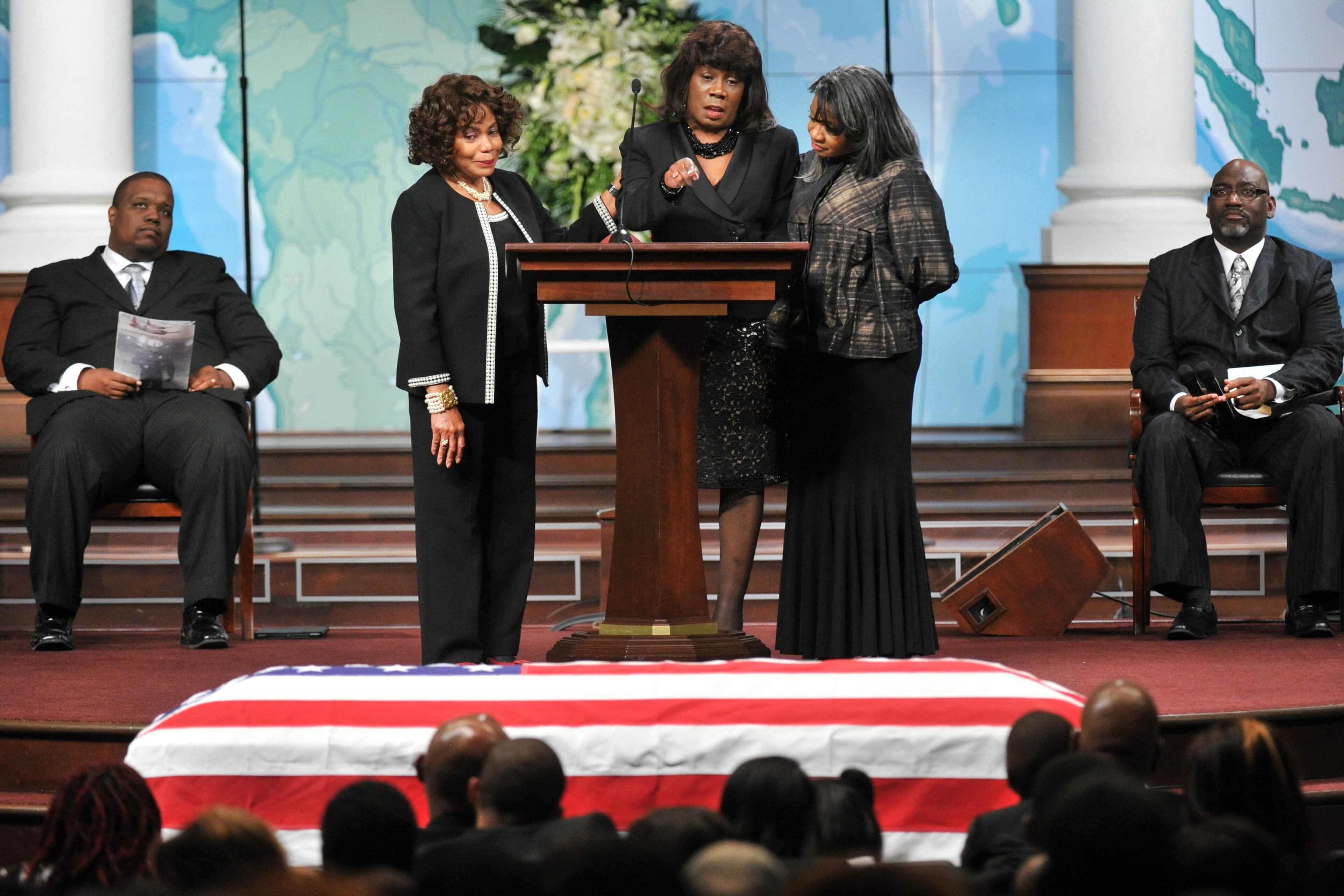 APD Officer Shawn Smiley's mother Carol Smiley (center) points her finger to her son's casket as she shares her memory of her son during APD Officer Shawn Smiley's funeral at First Baptist Church of Atlanta on Saturday, November 10, 2012. APD Officer Shawn Smiley was in the passenger seat last weekend when an APD helicopter searching for a missing 9-year-old boy crashed in Atlanta. HYOSUB SHIN / HSHIN@AJC.COM