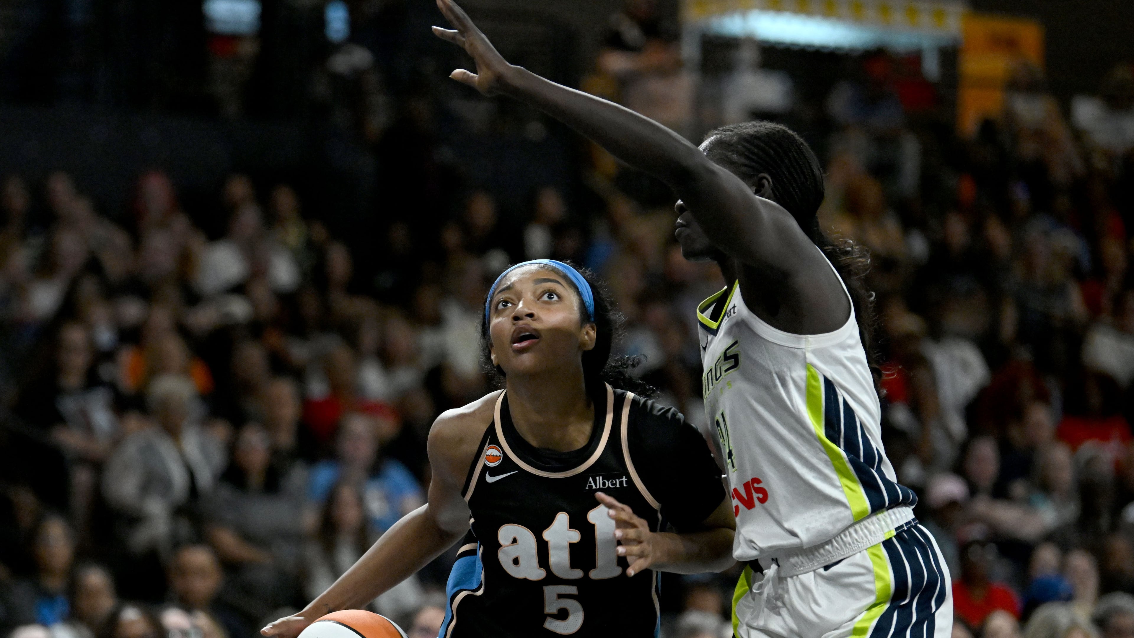 Atlanta Dream forward Angel Reese (5) drives against Dallas Wings forward Awak Kuier (34) during the second half of a WNBA game at Gateway Center Arena on Friday, May 22, 2026, in Atlanta. Atlanta Dream won 86-69 over Dallas Wings. (Hyosub Shin/AJC)