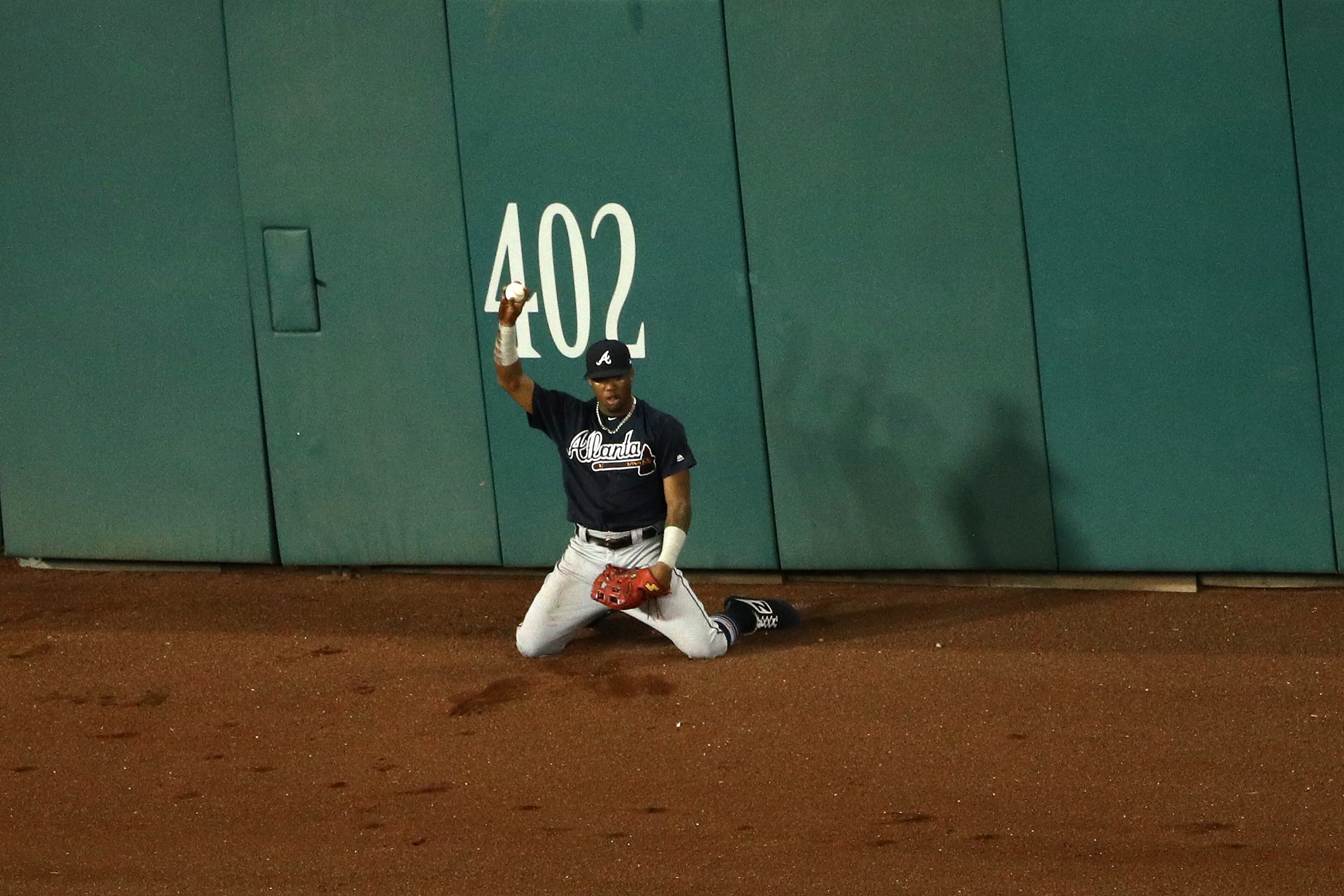 WASHINGTON, DC - AUGUST 08: Ronald Acuna Jr. #13 of the Atlanta Braves makes a catch on a hit by Matt Adams #15 of the Washington Nationals (not pictured) during the fourth inning at Nationals Park on August 8, 2018 in Washington, DC. (Photo by Patrick Smith/Getty Images)