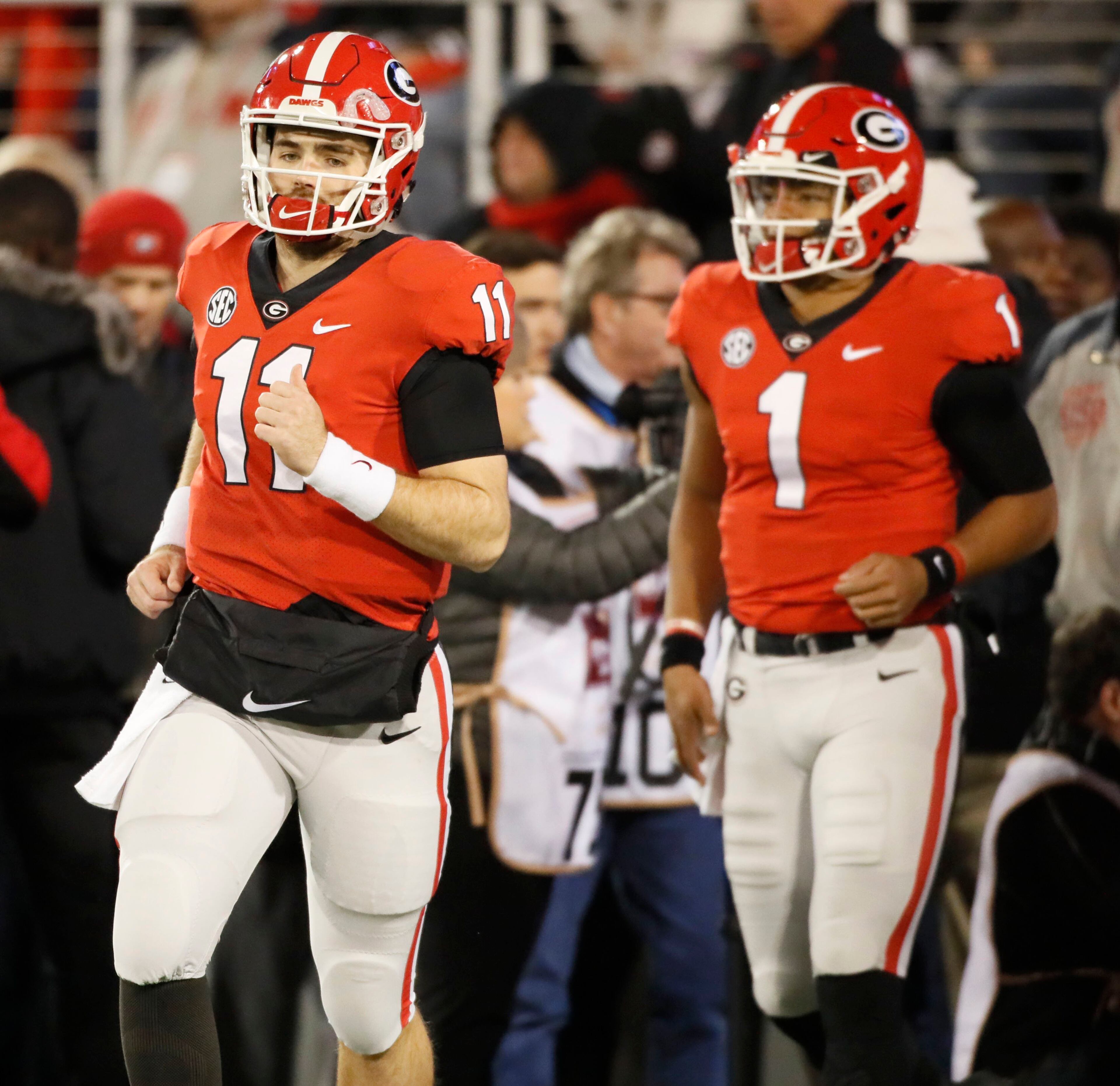 11/10/18 - Athens - Georgia Bulldogs quarterback Jake Fromm (11) and Georgia Bulldogs quarterback Justin Fields (1) take the field for pregame warmups. The University of Georgia Bulldogs played the Auburn Tigers in a NCAA college football game Saturday, Nov. 11th, 2018, at Sanford Stadium in Athens, GA. BOB ANDRES / BANDRES@AJC.COM