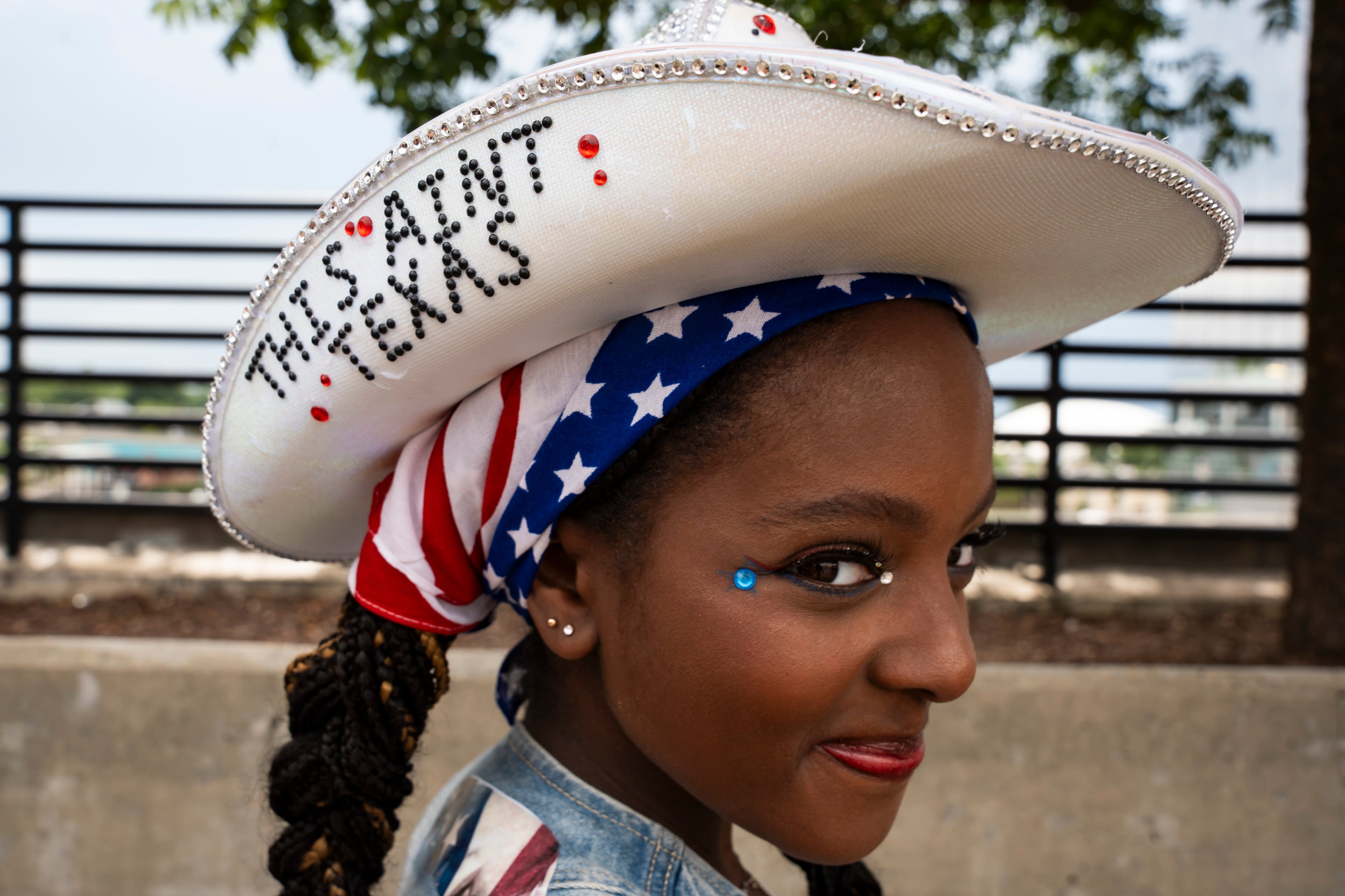 Tia Fisher poses wearing her home-bedazzled hat in line at Beyoncé's Cowboy Carter concert in Atlanta on Thursday, July 10, 2025. (Olivia Bowdoin for the AJC)