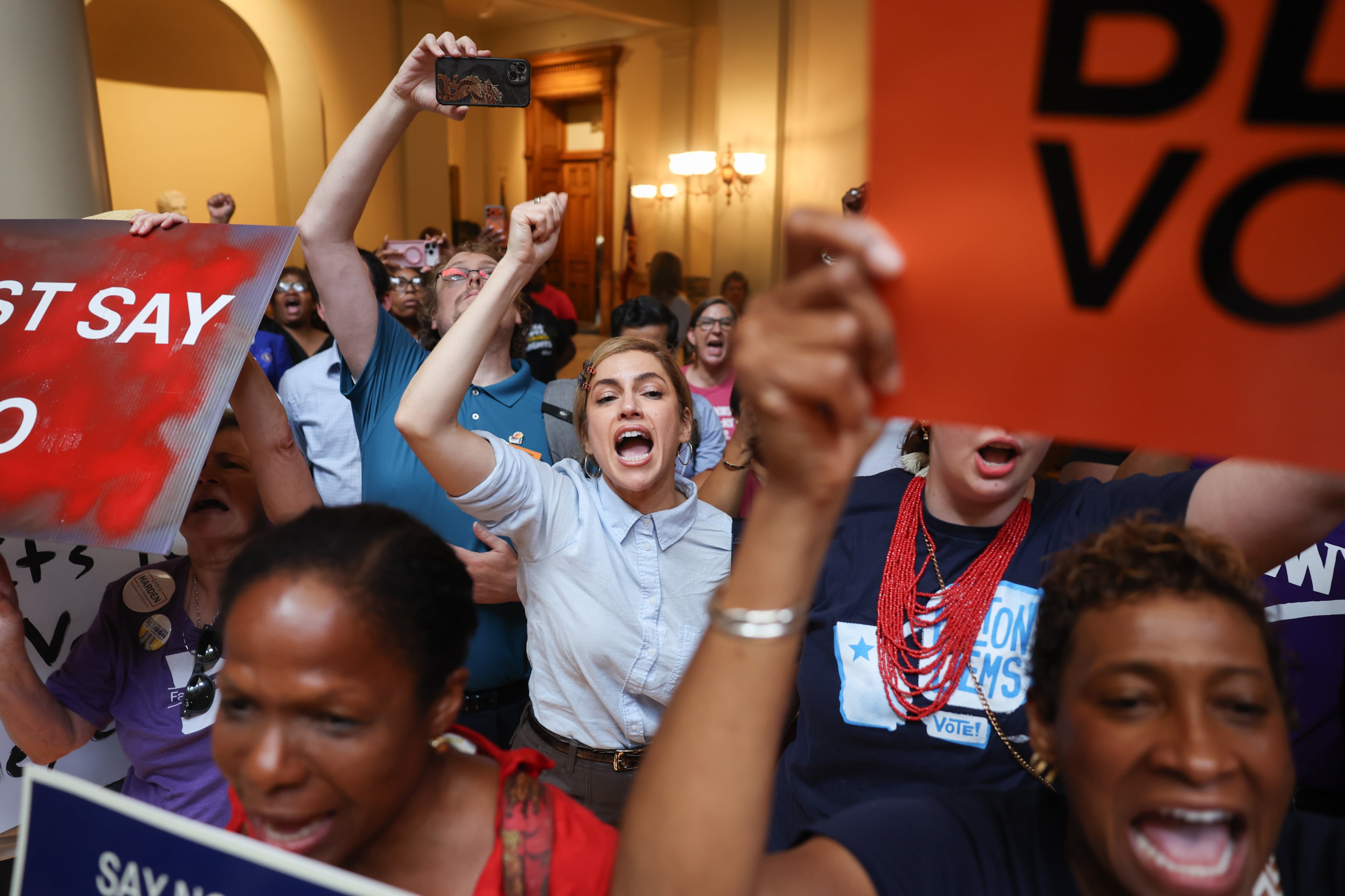 Activists opposed to redistricting react during a Republican press conference about redrawing the state’s political maps at the Capitol in Atlanta on June 17, 2026. (Arvin Temkar/AJC)