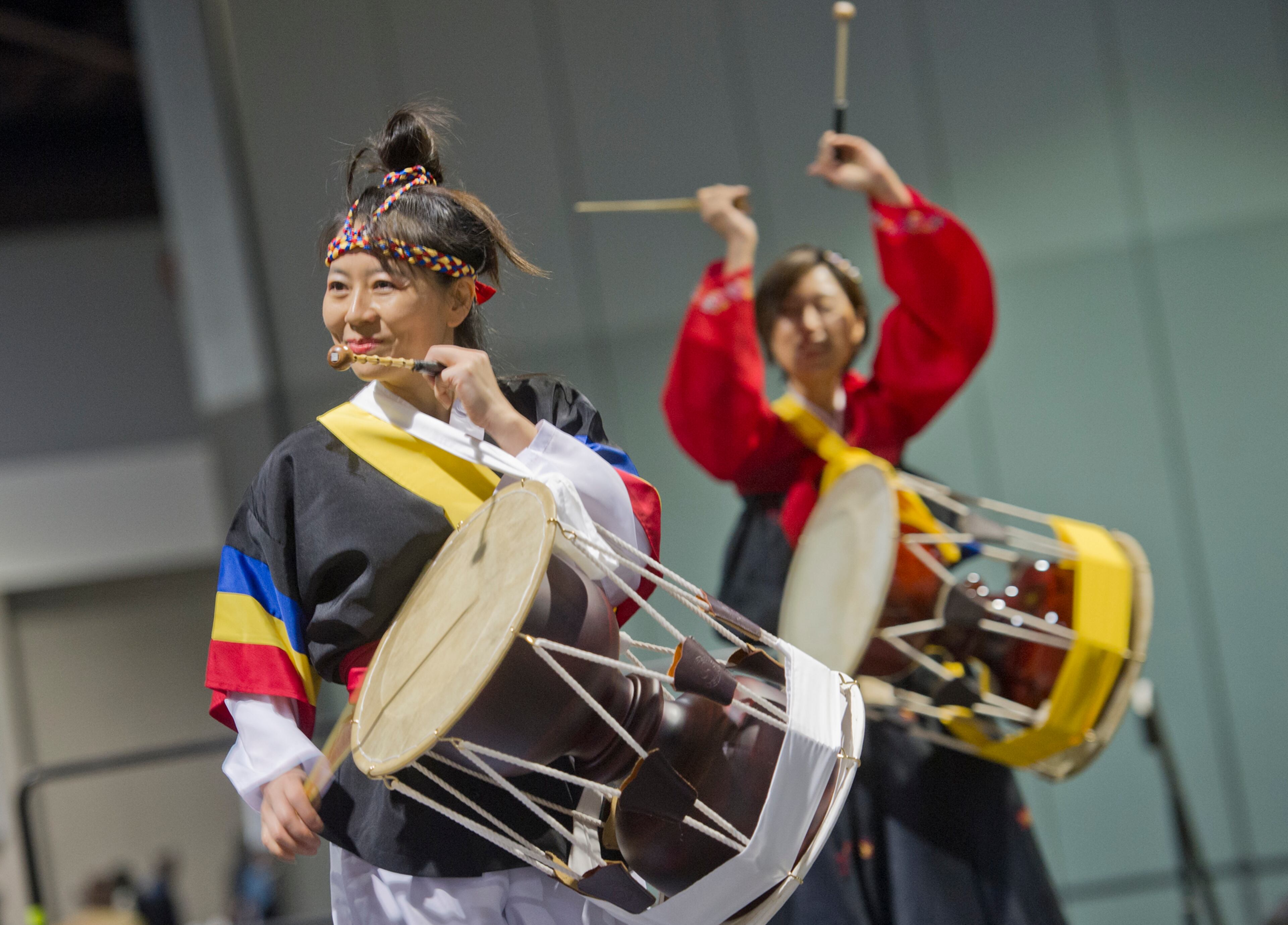 Christine Lee (left) and Angela Oh perform on stage during the Hosea Feed the Hungry and Homeless annual Thanksgiving meal at the Georgia World Congress Center in Atlanta on Nov. 28, 2013.